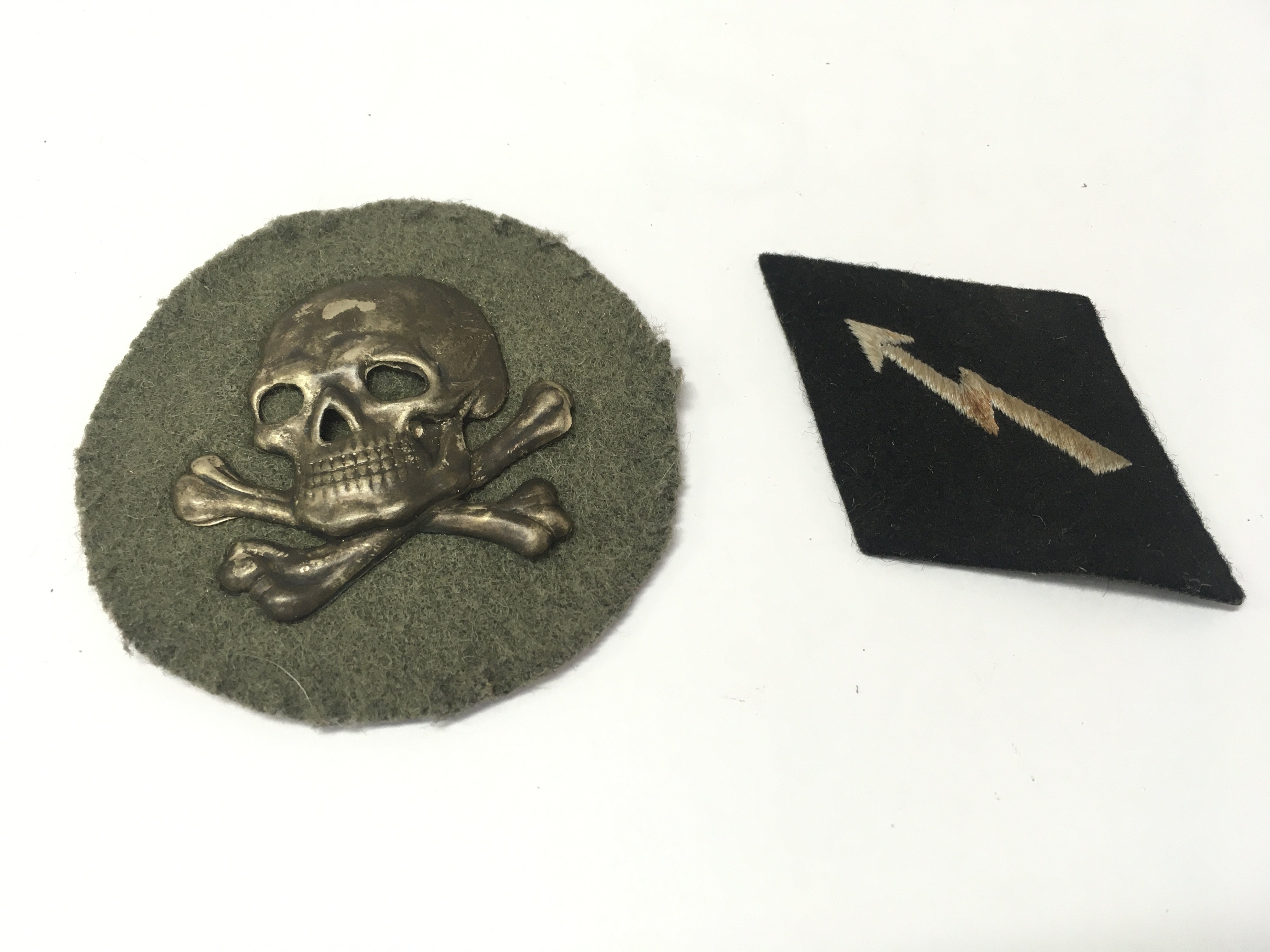 A WW1 German Flammenwerfer (Flame Thrower) Officers sleeve Badge and a WW2 Third Reich SS signals badge . Postage category A