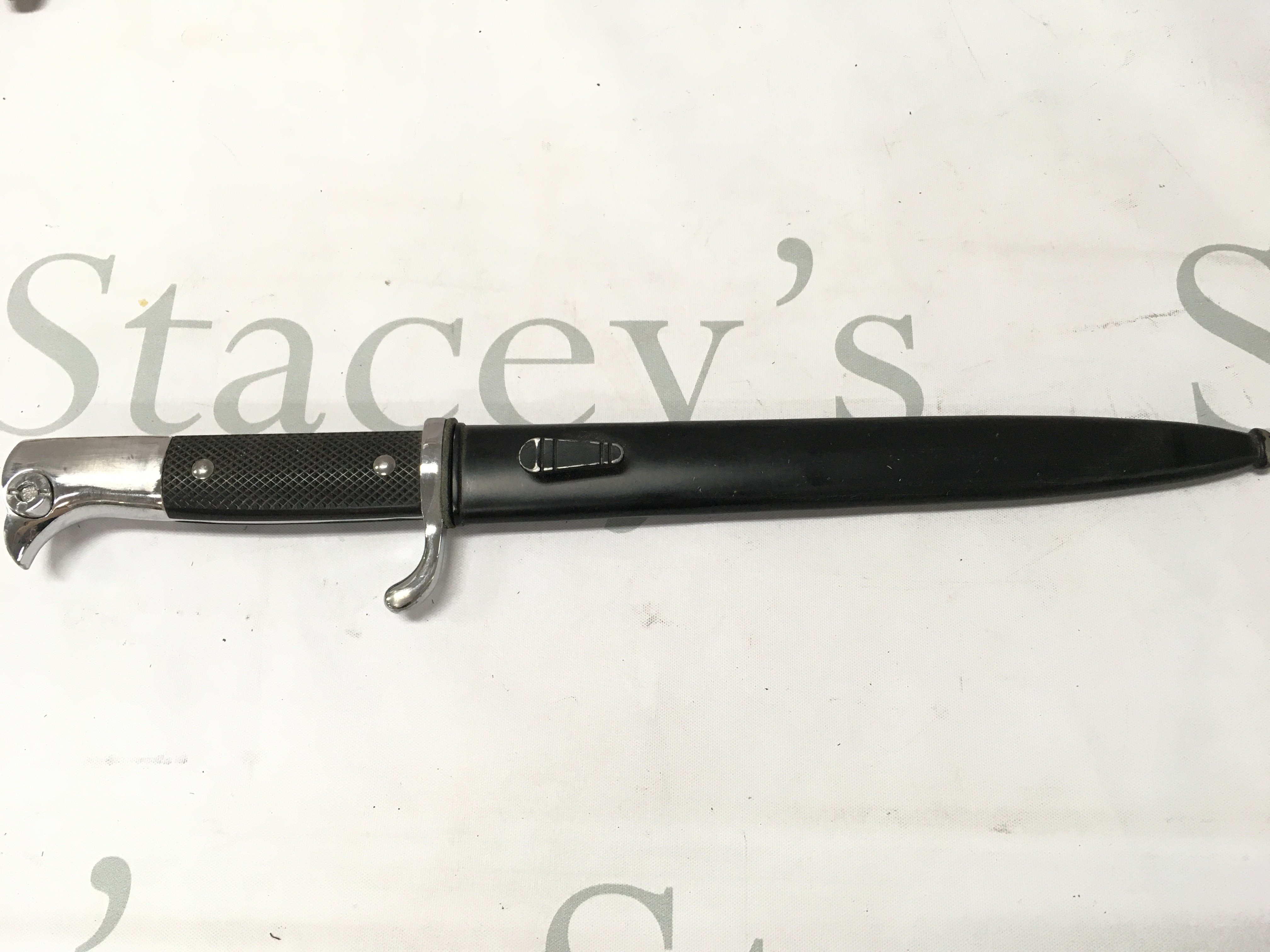 A German dress bayonet and scabbard , 34cm total length , 22cm blade long. This lot cannot be posted