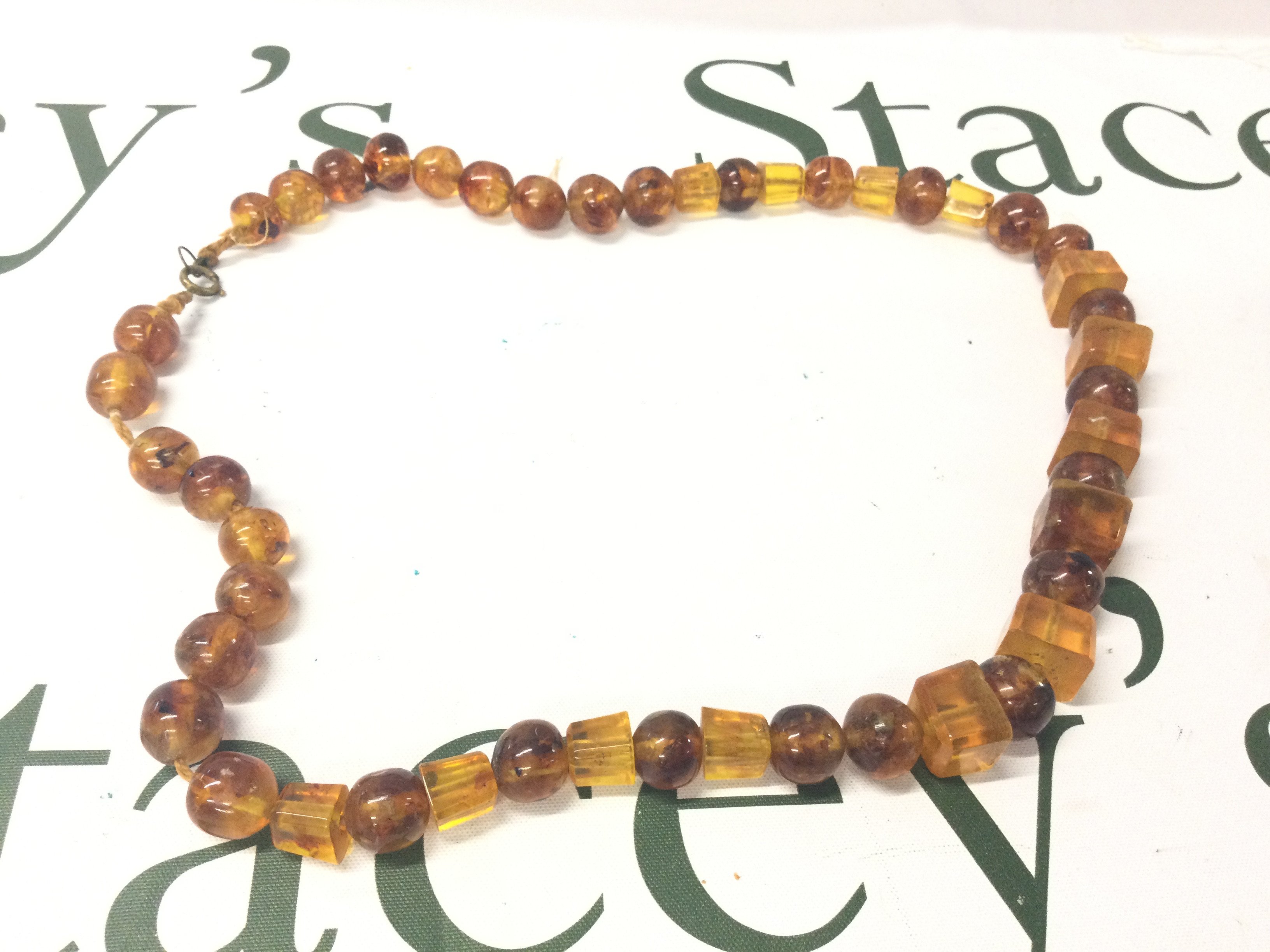 A Bakelite Amber Necklace, 30cm long. 75g. Postage category A