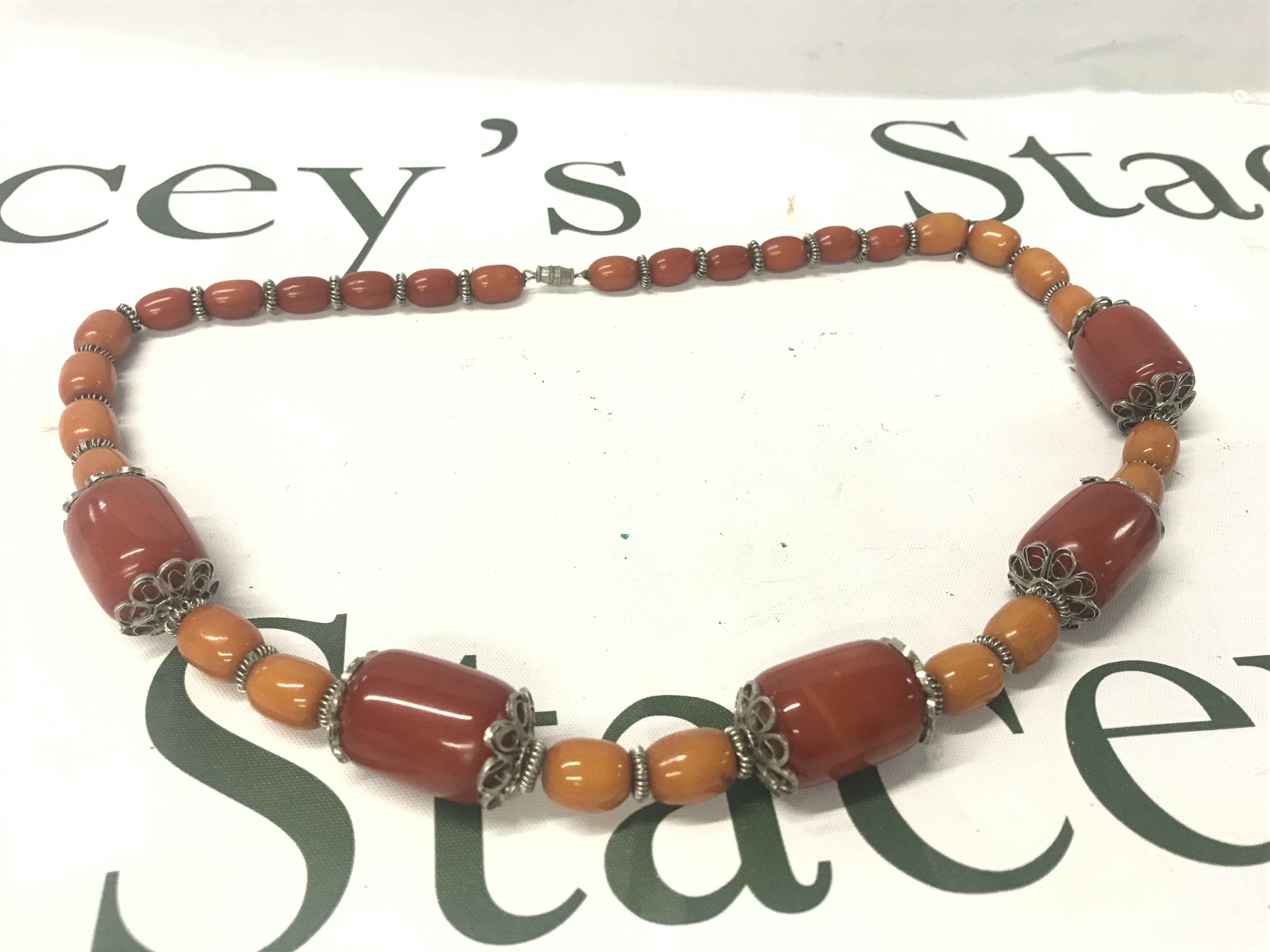 A Bakelite and silver colour necklace, 95g, 64cm long. Postage category A