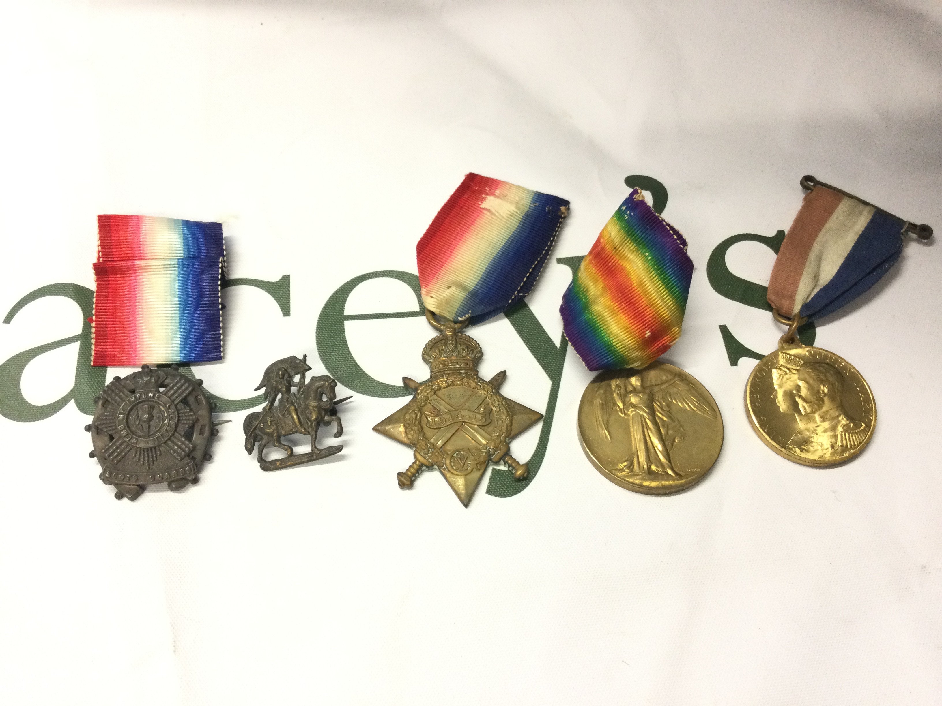 First World War medals awarded to N.G.Preddy CH STO R N along with two silver cap badges. Postage B