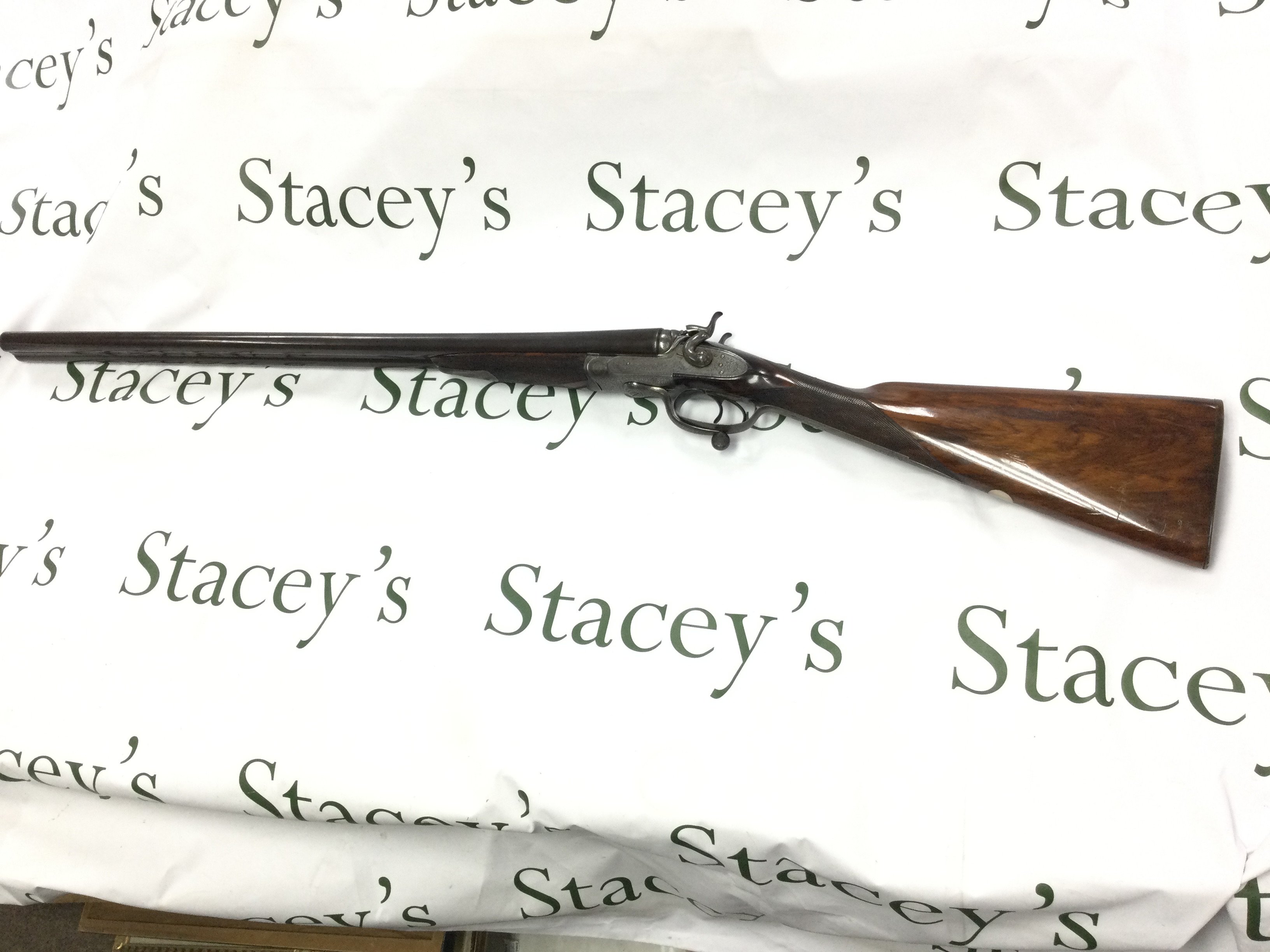 A fine example of a 12 gauge side by side hammer shotgun by George Gibbs. Features nice detailed scroll engraving to side and a walnut stock. 28inch barrel and 44.5 inches overall. Serial number 6261. PLEASE NOTE THAT A SHOTGUN LICENSE IS REQUIRED TO PURCHASE THIS ITEM. COLLECTION AND VIEWING BY APPOINTMENT ONLY.