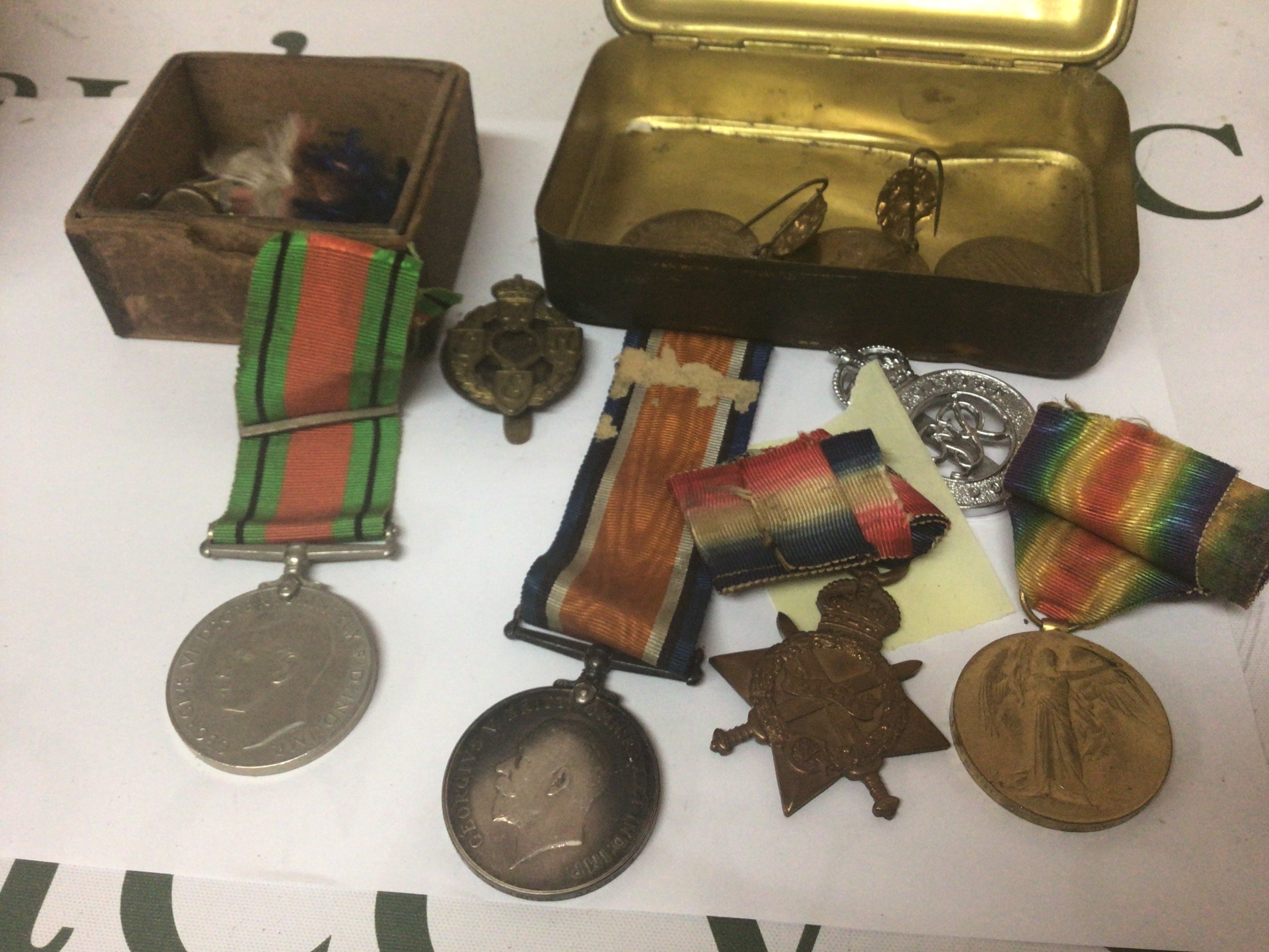 A group of I world war medals including 1914/15 star awarded to 18715 Pte J G Brown Devon R a II world war medals other military badges a Christmas tin and other oddments.