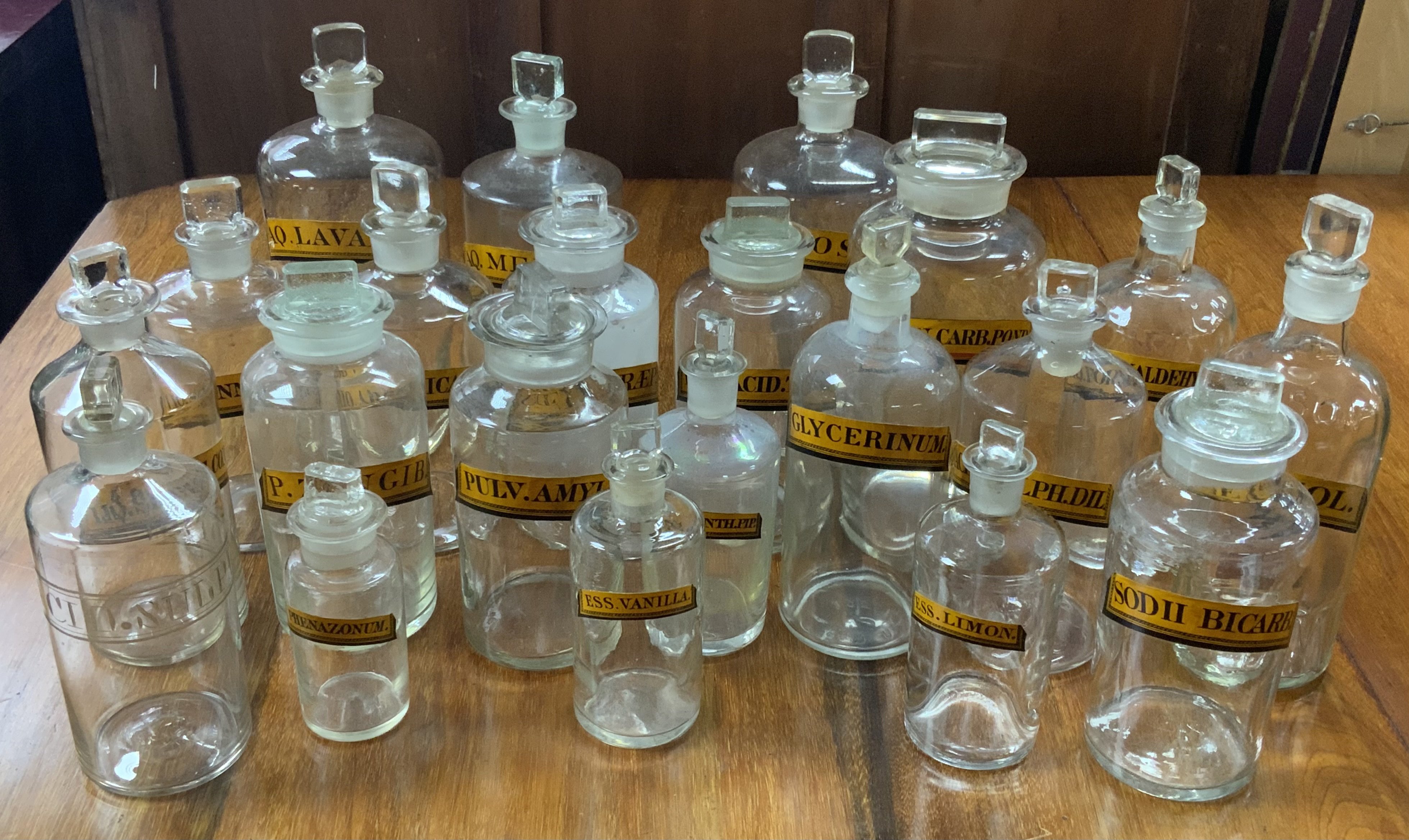 A good collection of 19th Century paper label apothecary jars. (21).