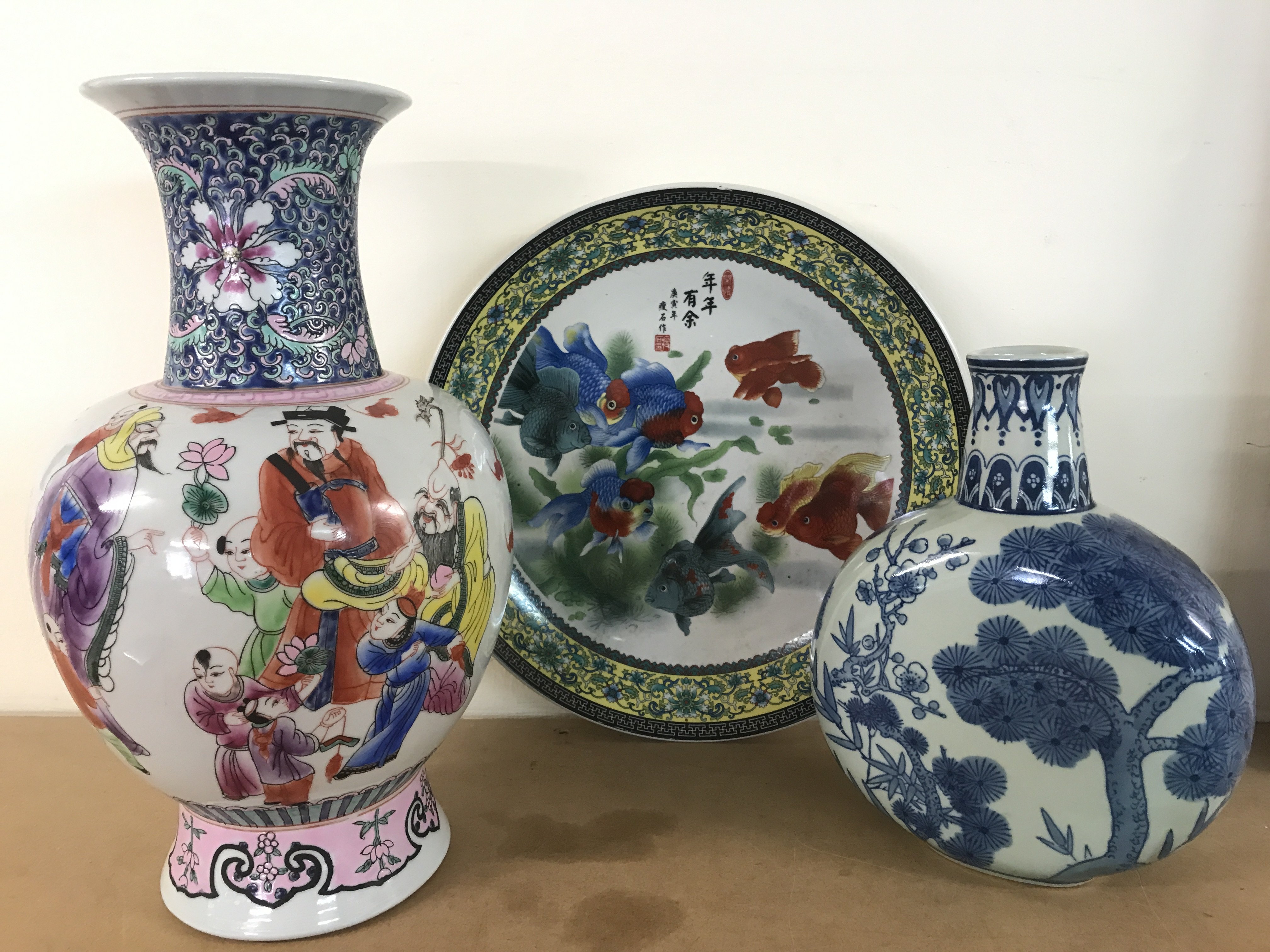 Chinese porcelain including a gold fish platter (34cm wide), a blue and white porcelain vase (25.5cm tall) with floral patterns and a Famille Rose vase (37.5cm tall). This lot cannot be posted