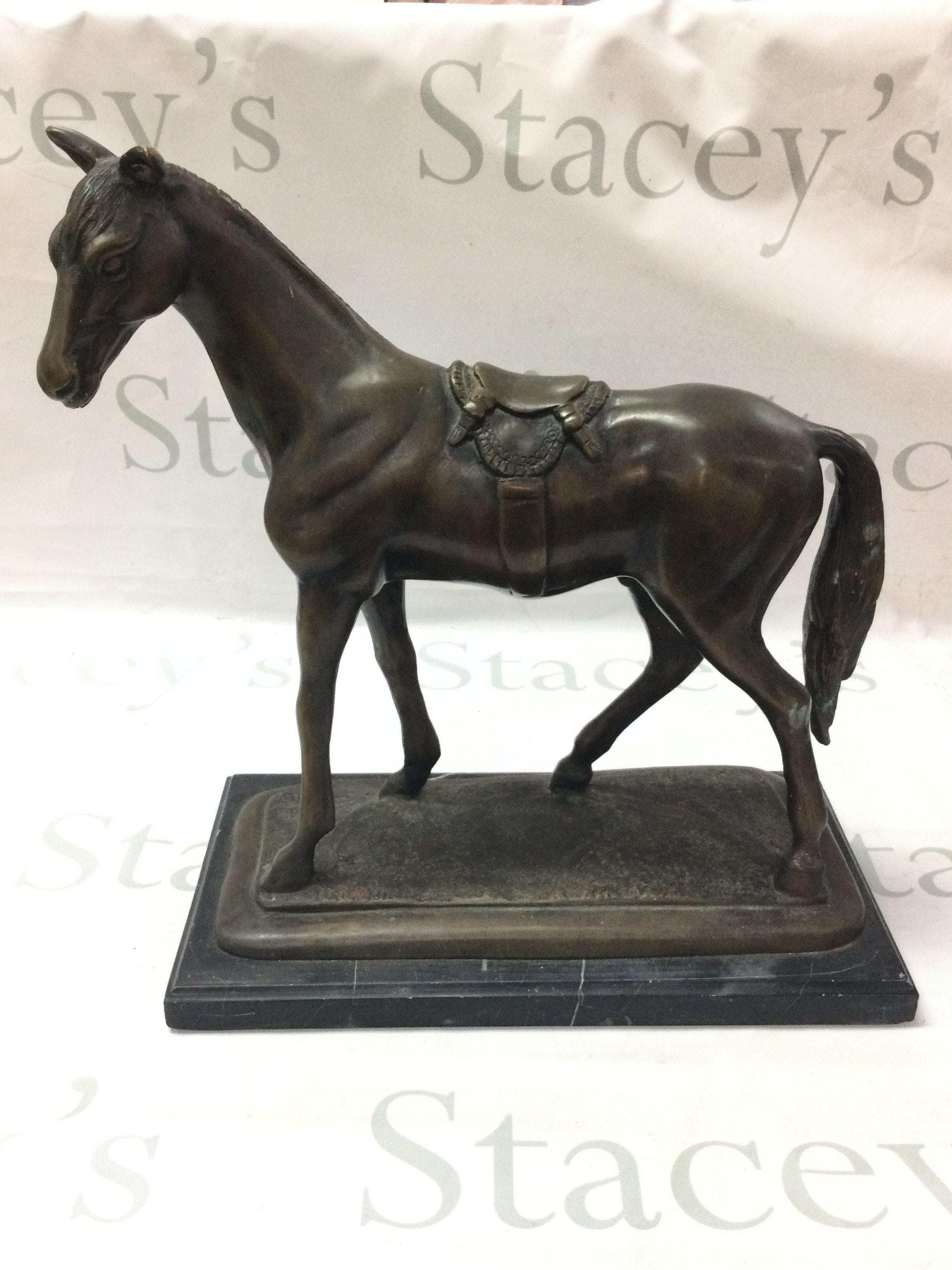 A bronze horse figure on a marble base ,34cm tall. Postage category C