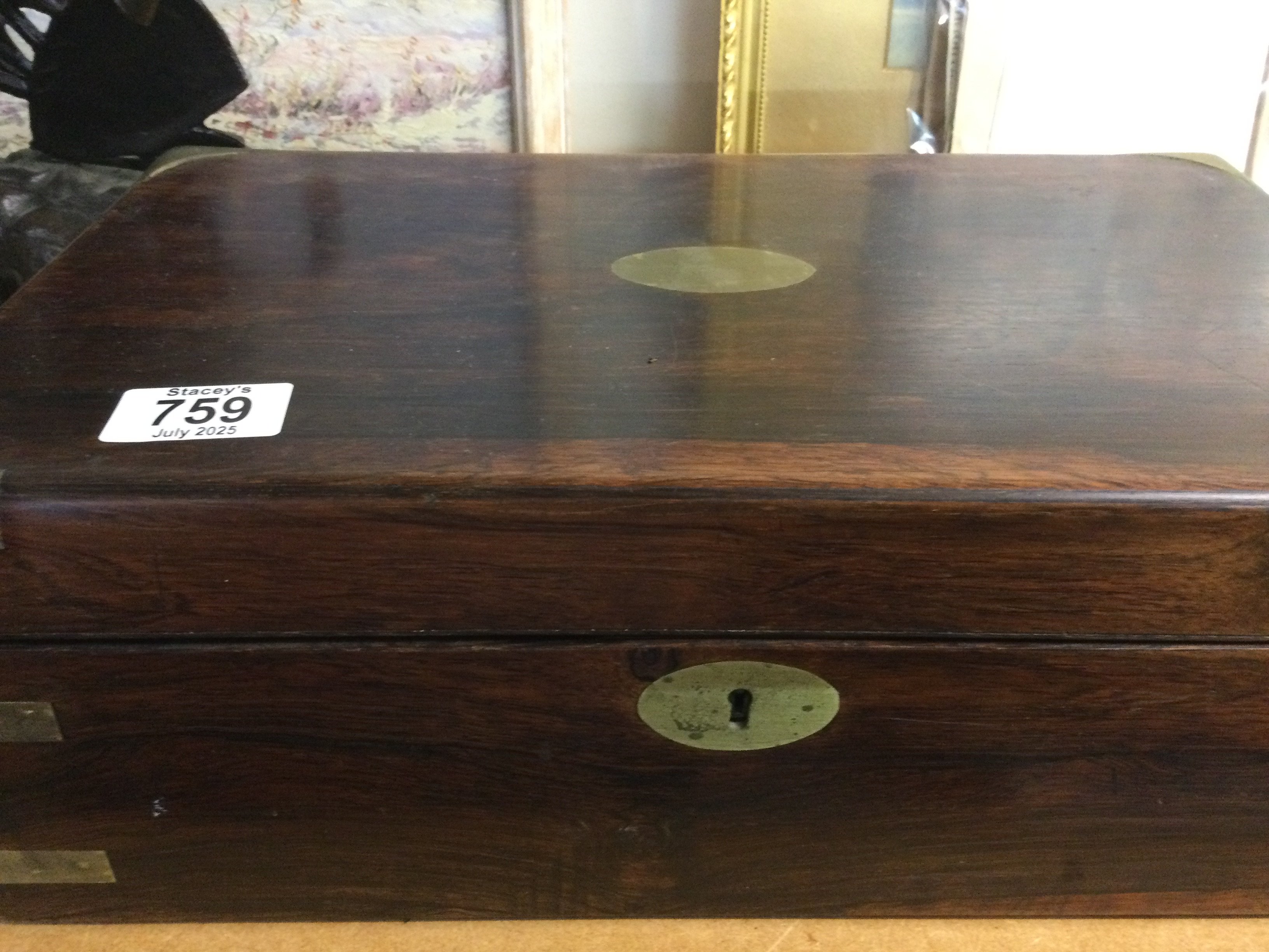 A mahogany brass bound writing slope with a fitted interior.