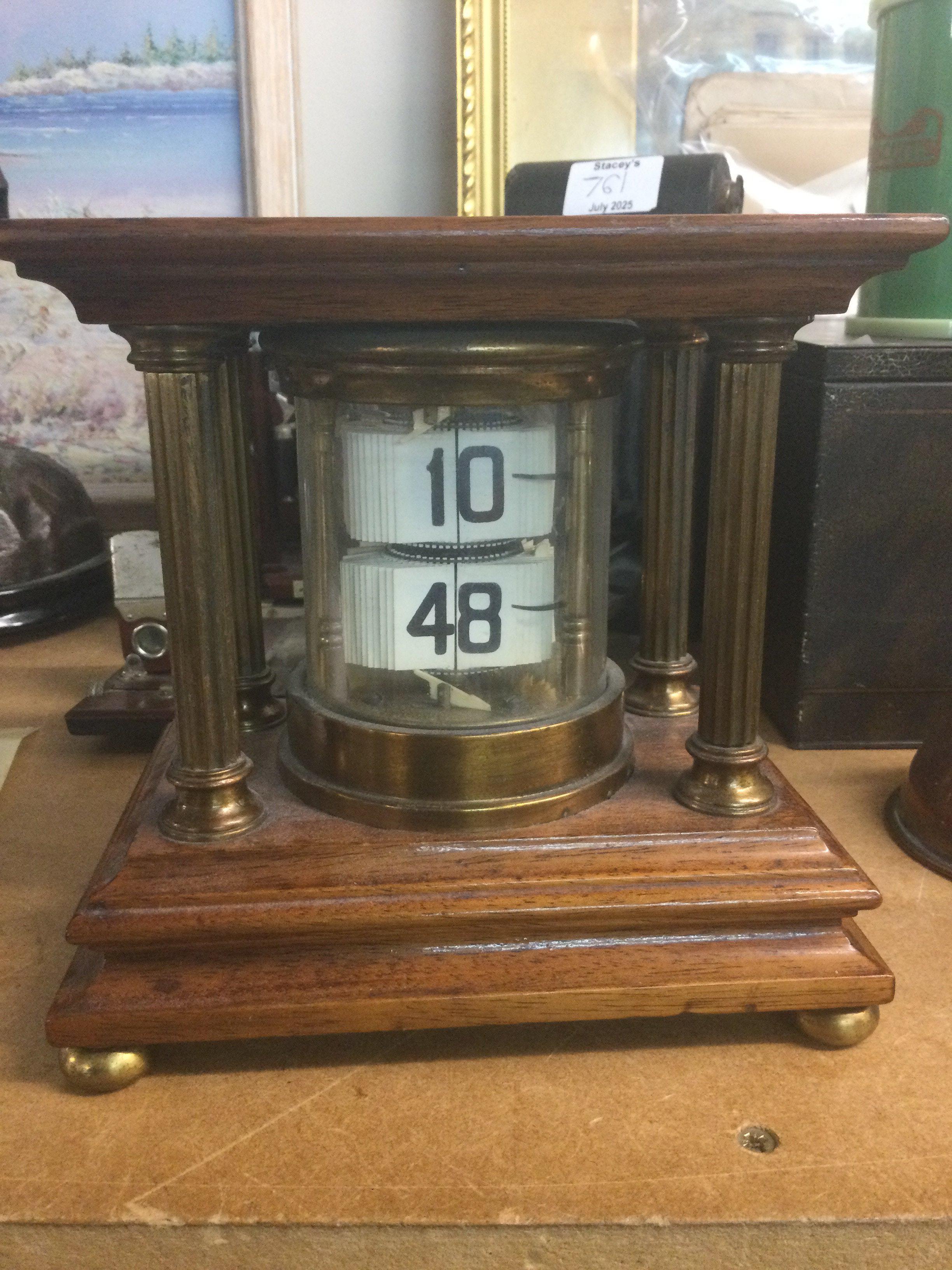 A mahogany case flip ticket clock .