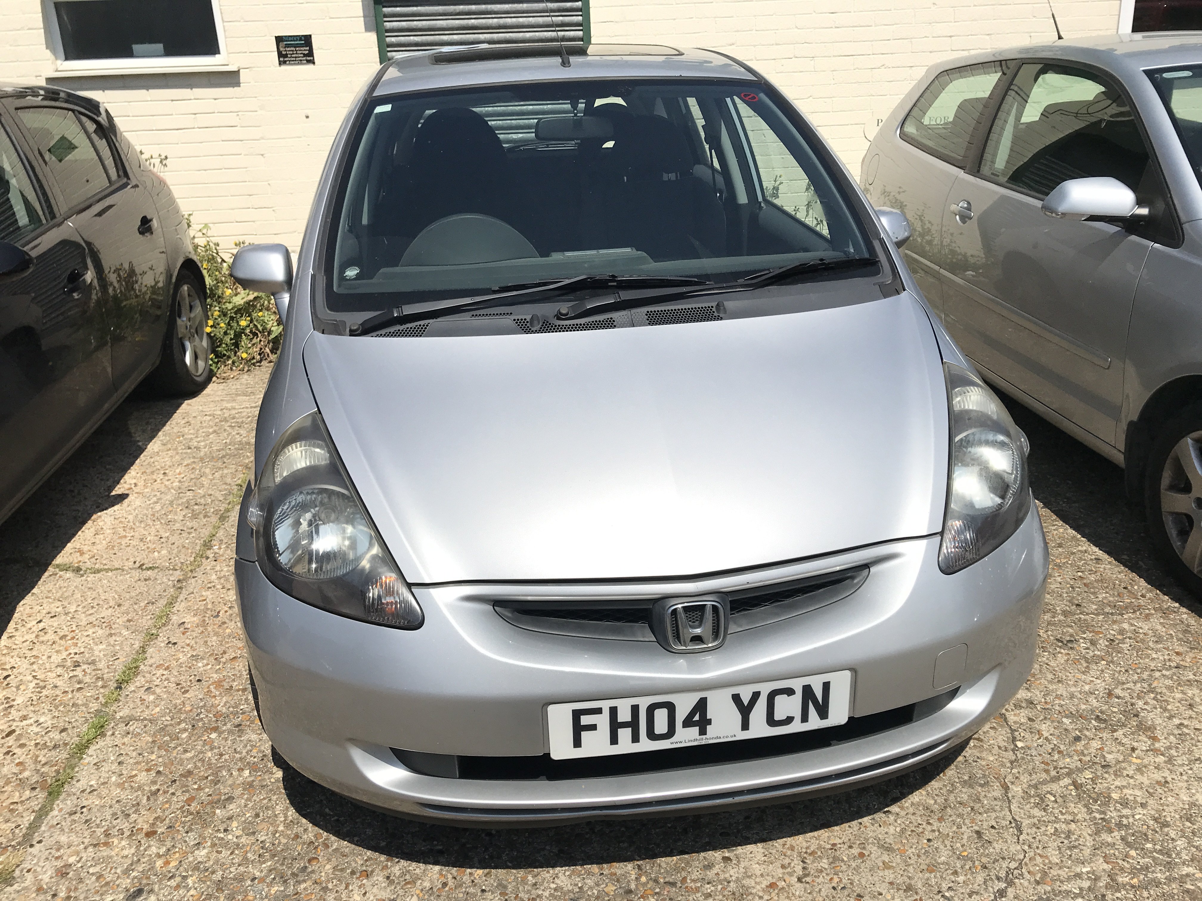 A silver Honda Jazz 1.4SE 5 door automatic. Registration number is FH04 YCN. Mileage 79877. 3 owners. Lasted service carried out in 20th March 2024 and extensive service details on prior services carried out. MOT until 3rd April 2026. Bodywork damage to front by bumper on passenger side and rear passenger door.