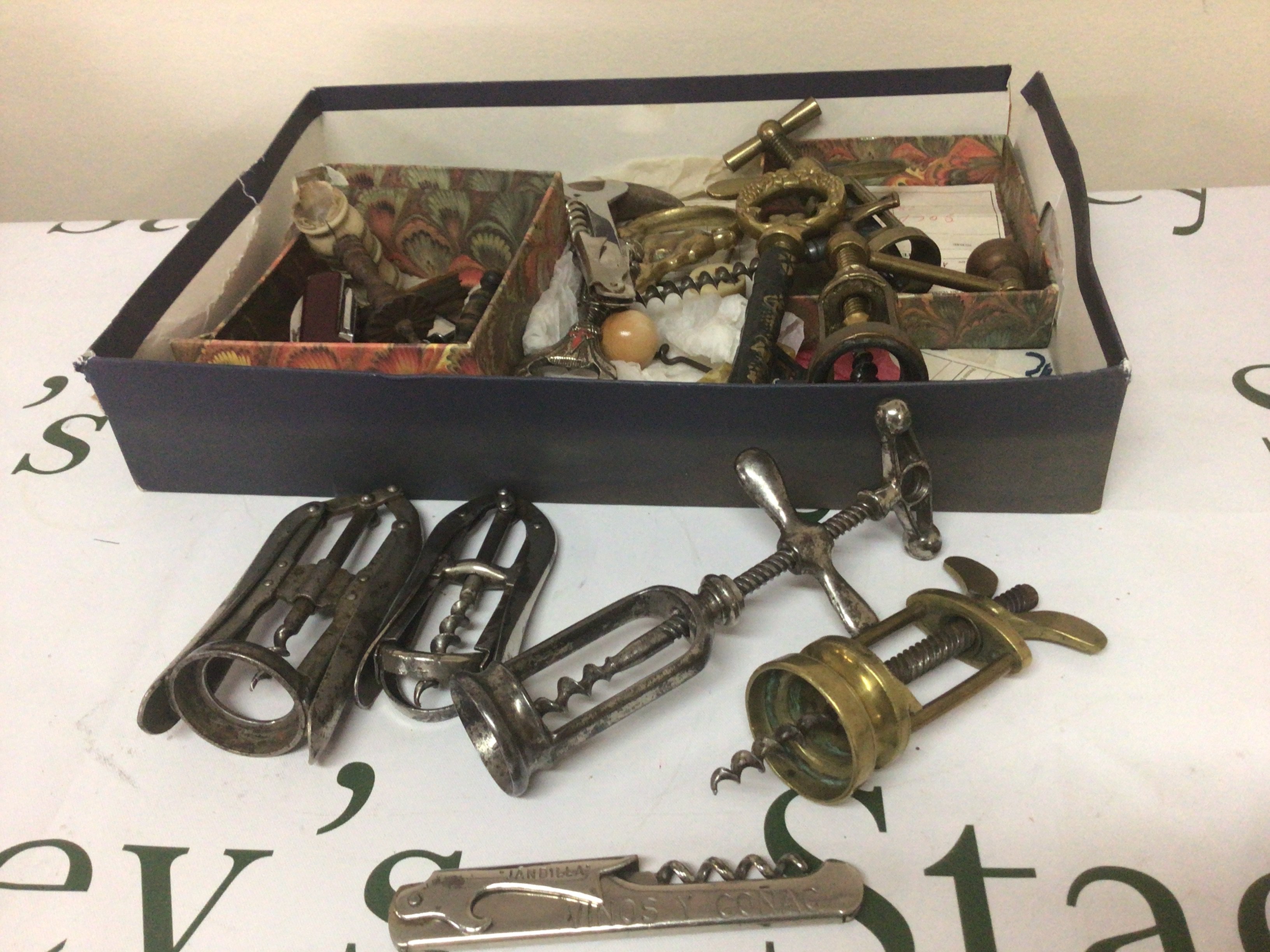 A collection of Vintage corkscrews pocket knifes and other conforming oddments.