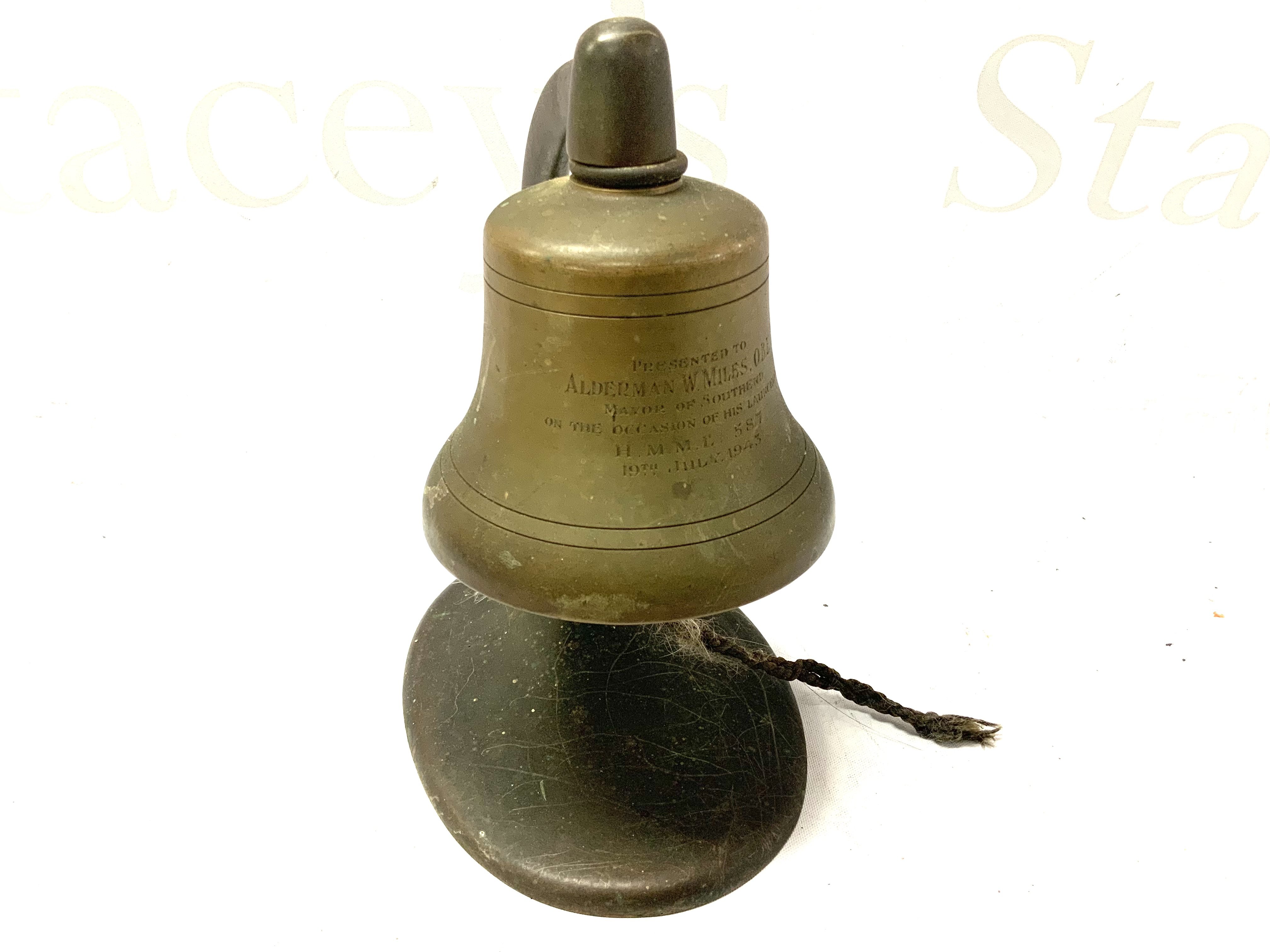 A small cast bronze desk bell and stand presented to Alderman W. Miles O.B.E (ref lot 701) for the occasion of landing H.M.M.E 387 July 1943. H.18cm
