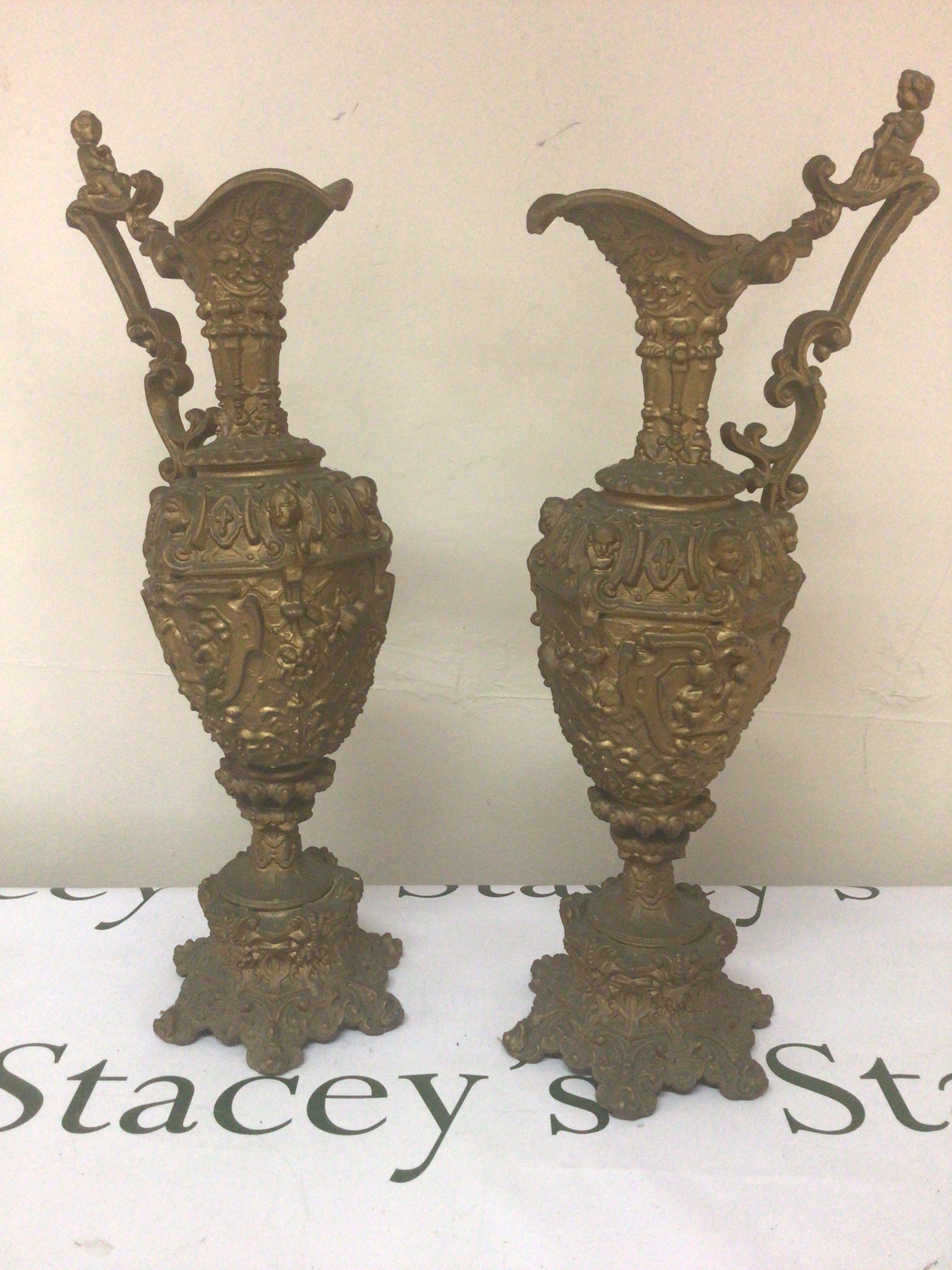 A pair of Victorian gold coloured spelter urns with perfuse decoration. Height 46cm