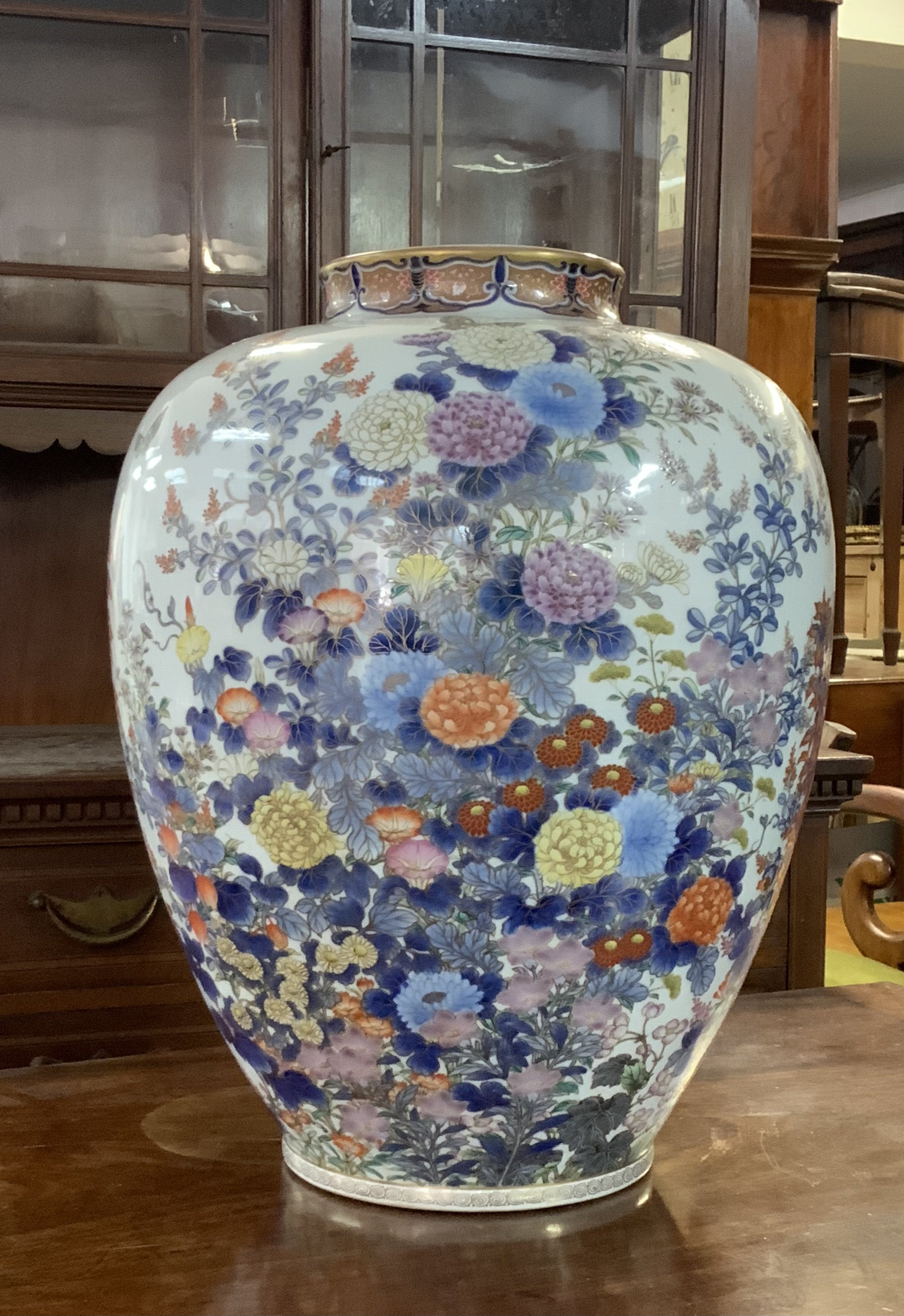 A good Koransha porcelain vase, c. 1880, the body painted in underglaze blue, Oranges, yellows and gilding to the chrysanthemums and foliage, underglaze blue signature, 40cm