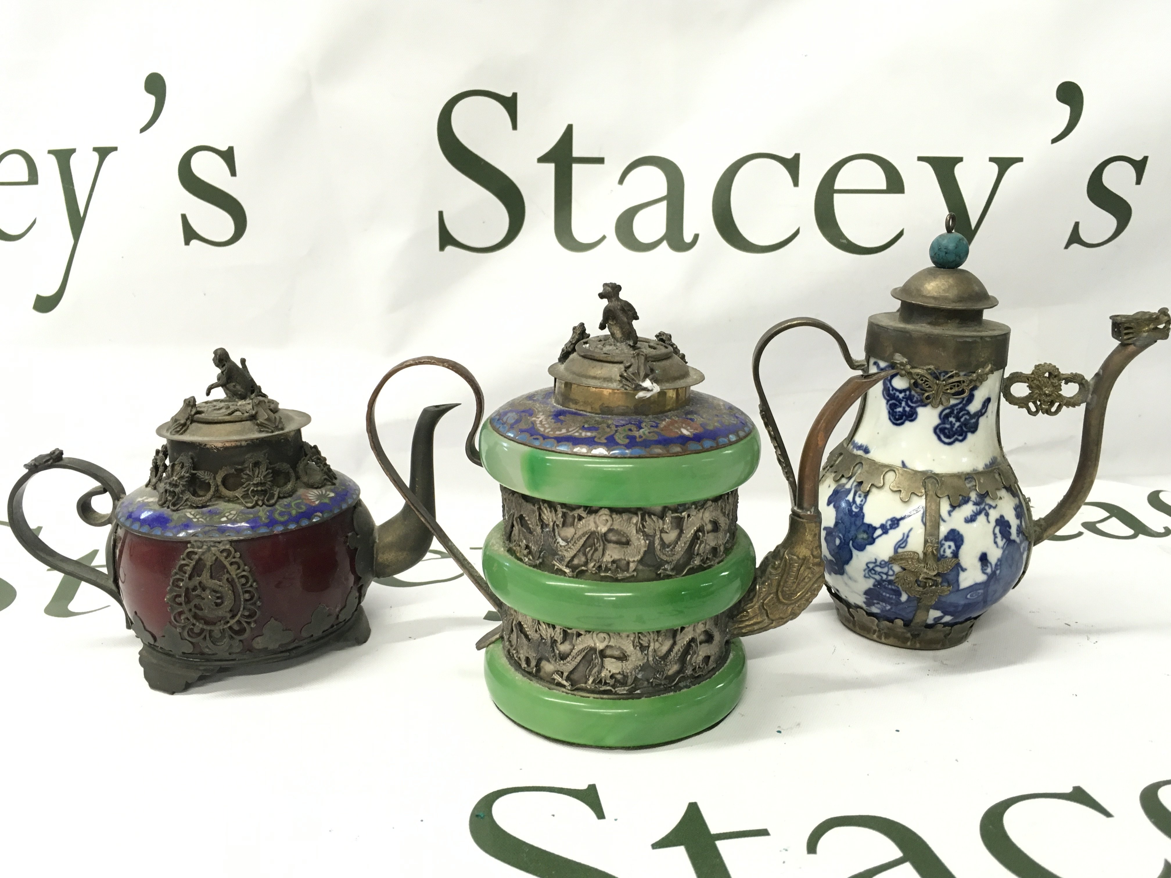 Three Chinese metal mounted tea pots. 9 to 12cm tall. With four character marks to base. This lot cannot be posted