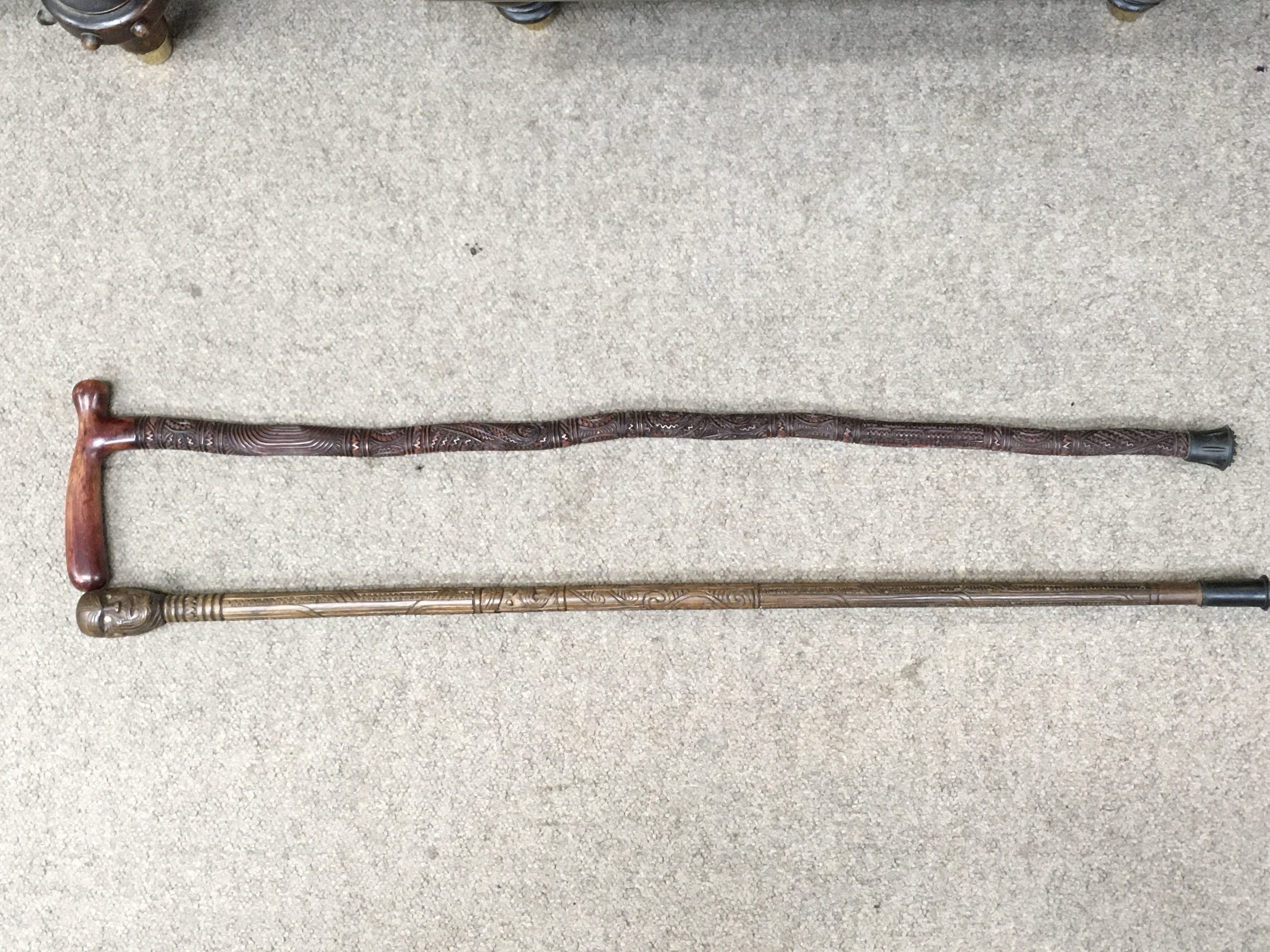 Two carved Maori walking sticks , 84cm long