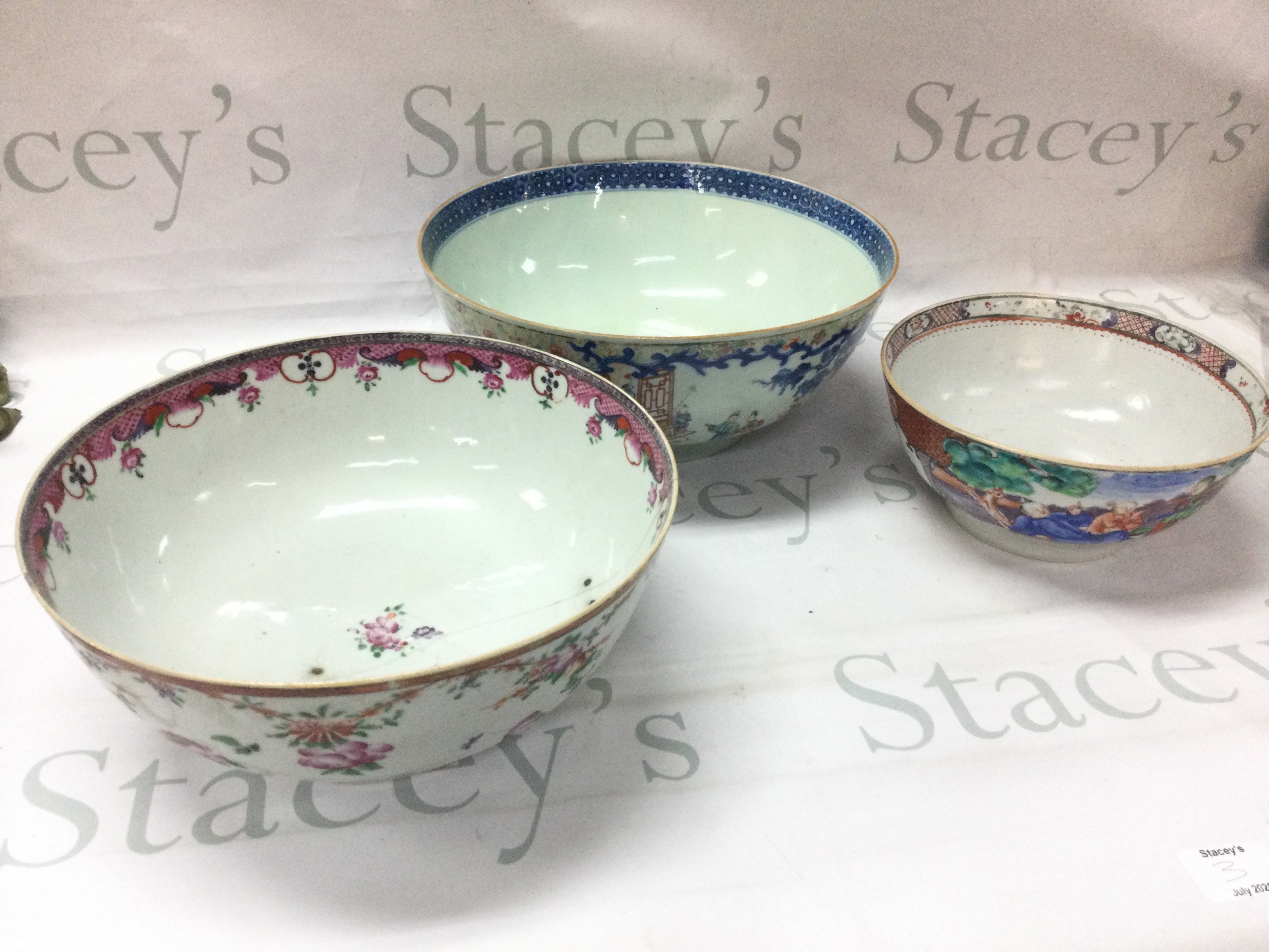 Chinese bowls including a Famille Rose Canton bowl, Famille Rose punch bowl (damaged with chips, hairline cracks and restoration) and another punch bowl decorated with figures. Dimensions ranging from 9cm tall 19cm wide to 12cm tall 28cm wide
