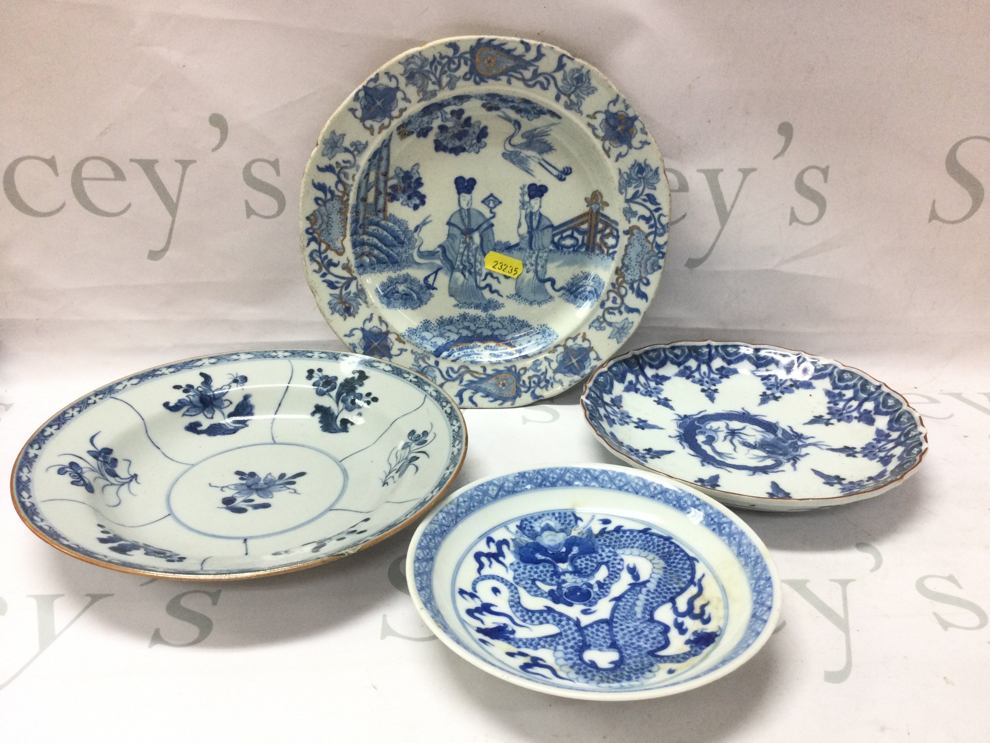 A collection of Chinese blue and white dishes including dragon design and a 19th century Masons ironstone figural scene dish. This lot cannot be posted