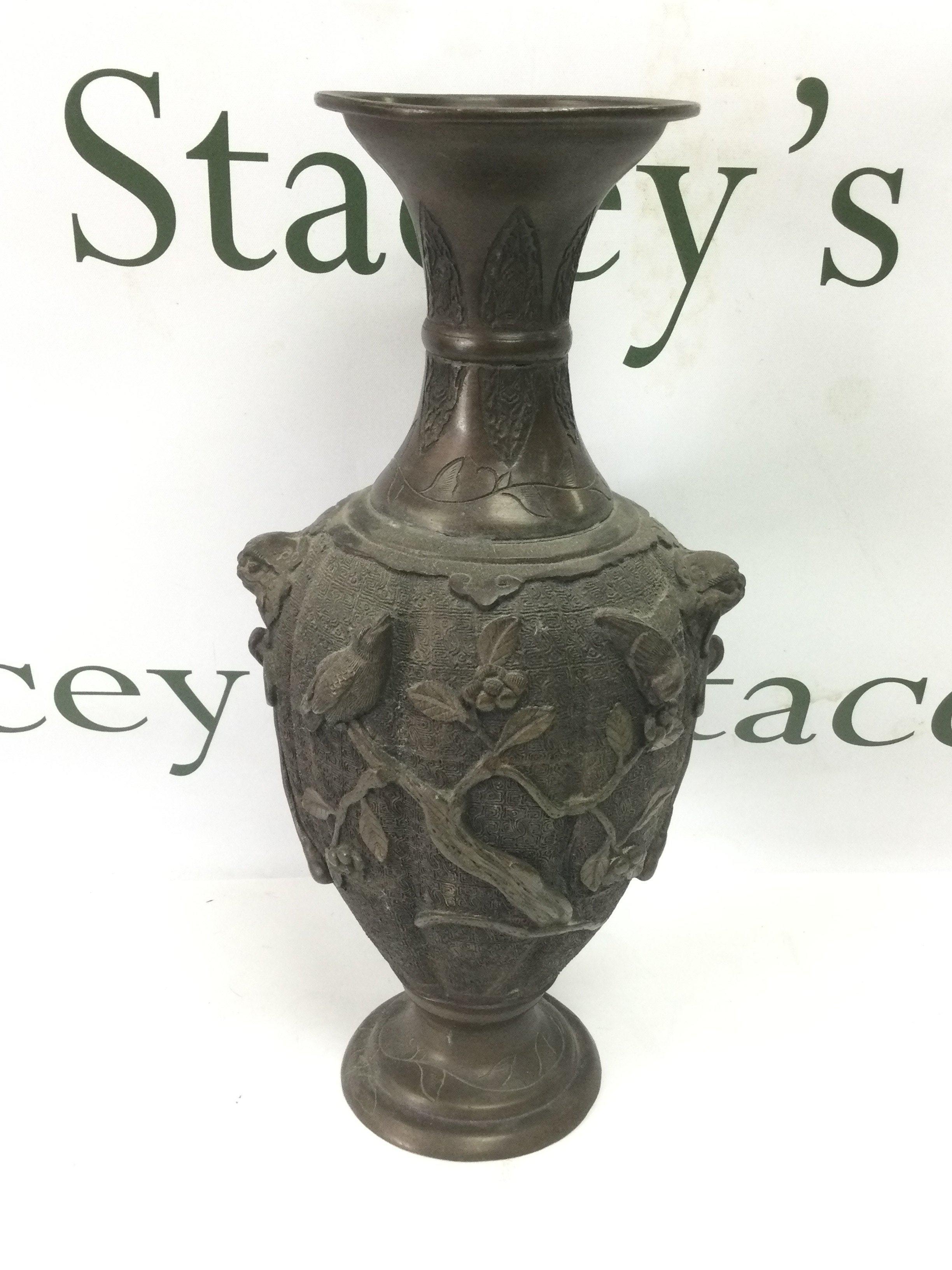 A Japanese bronzed vase decorated with applied birds amongst foliage, approx height 33cm. Shipping category C.