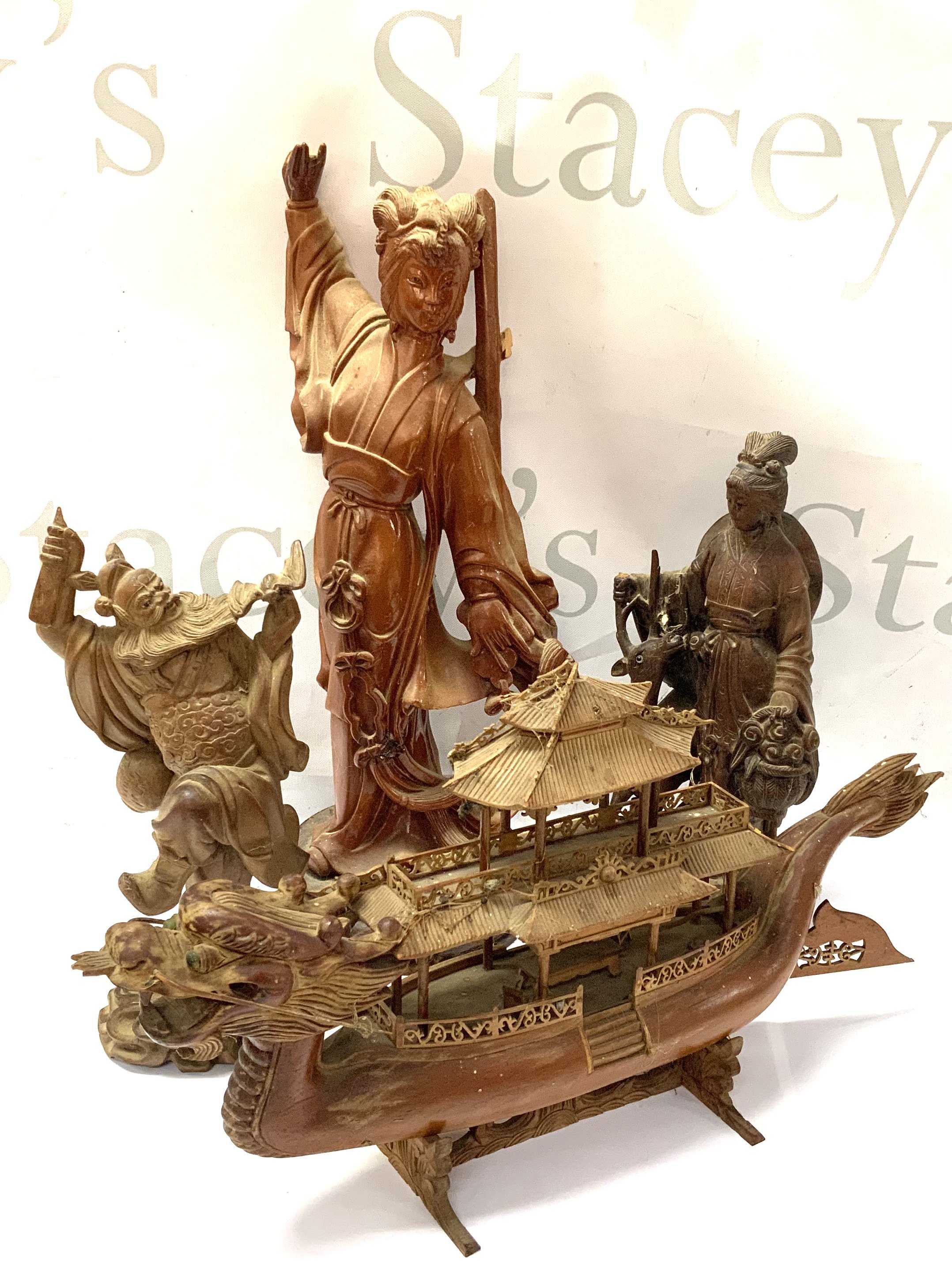 3 Carved Chinese figures of deity&rsquo;s together with a carved Chinese dragon boat
