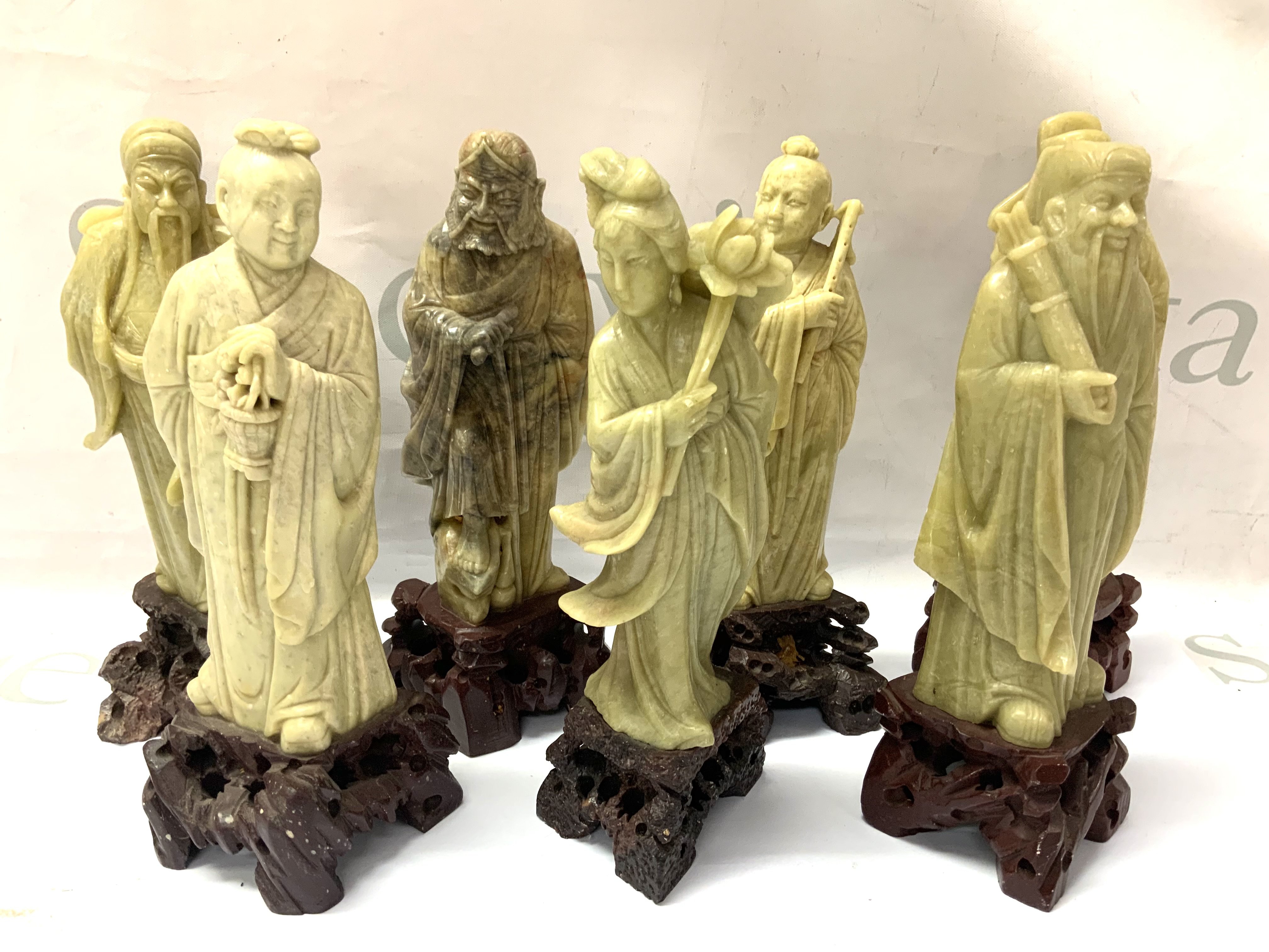 7 carved soapstone deity figures, Approx 20cm.