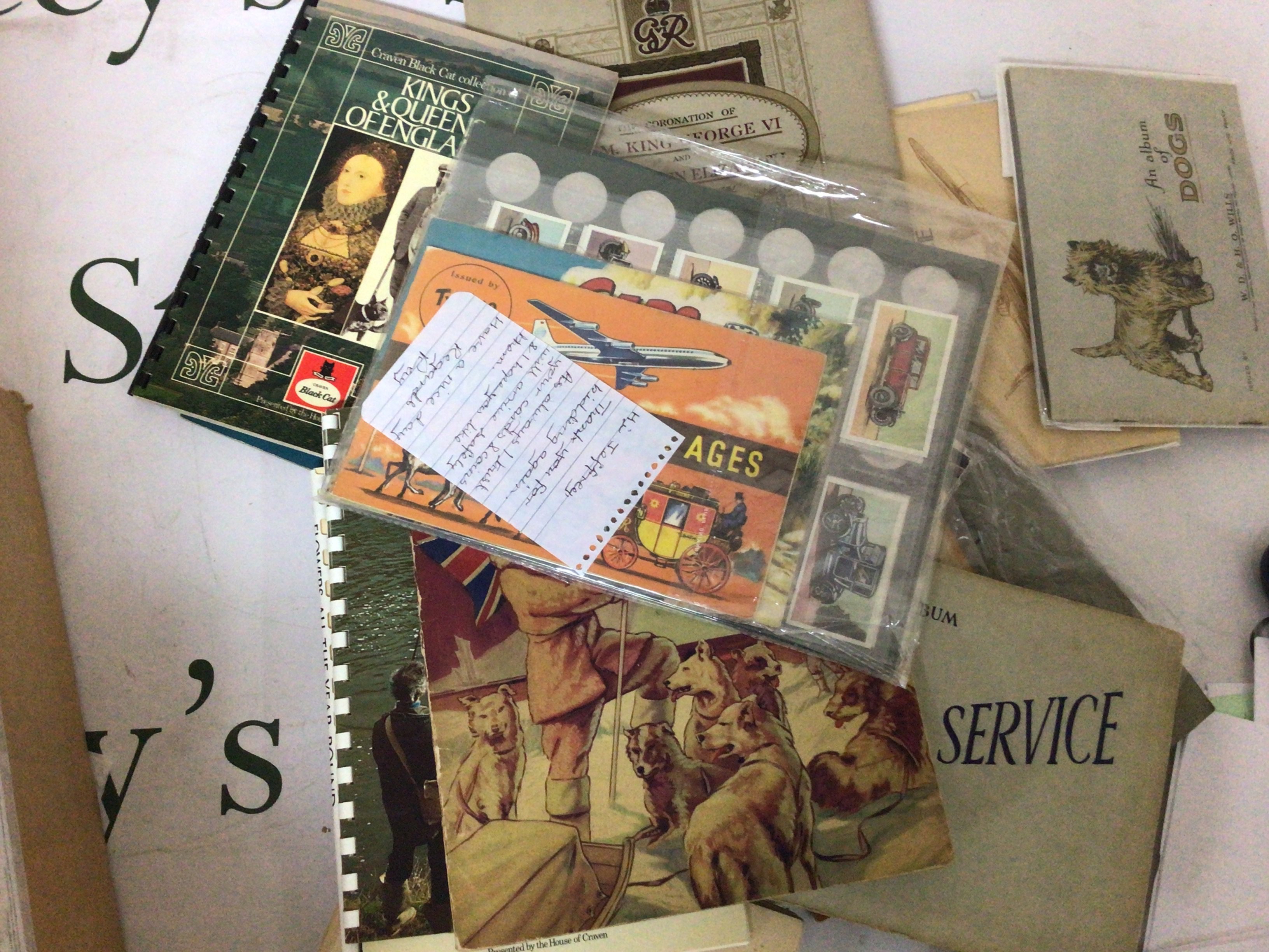 A box containing albums of cigarette and tea cards Film stars trains Blackshaw cat Sport fishing British Marvels Historic cars Shell coin sets and numerous others.