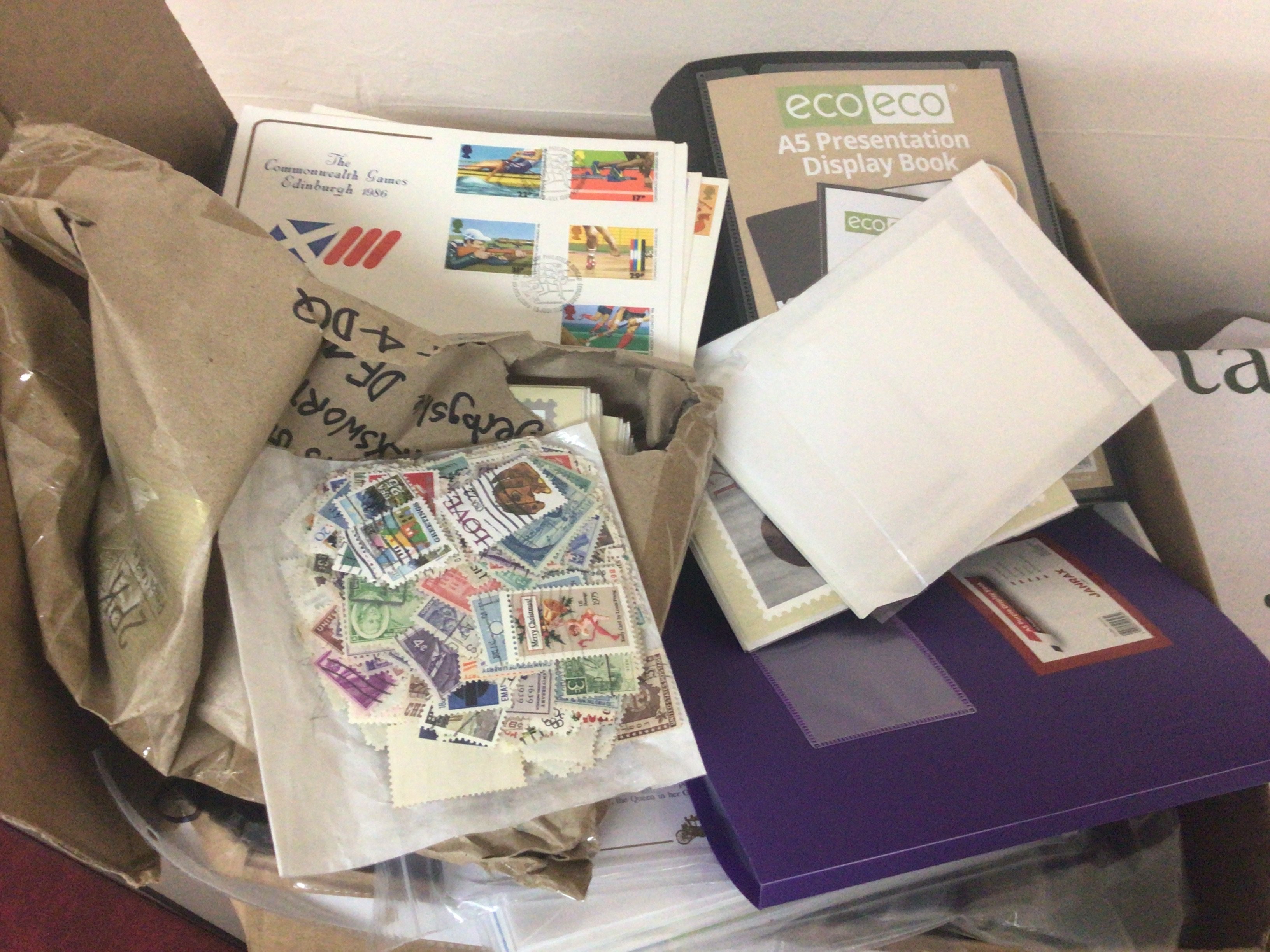 A box containing first day covers playing cards a few presentation packs and albums containing post office picture cards PHQ.