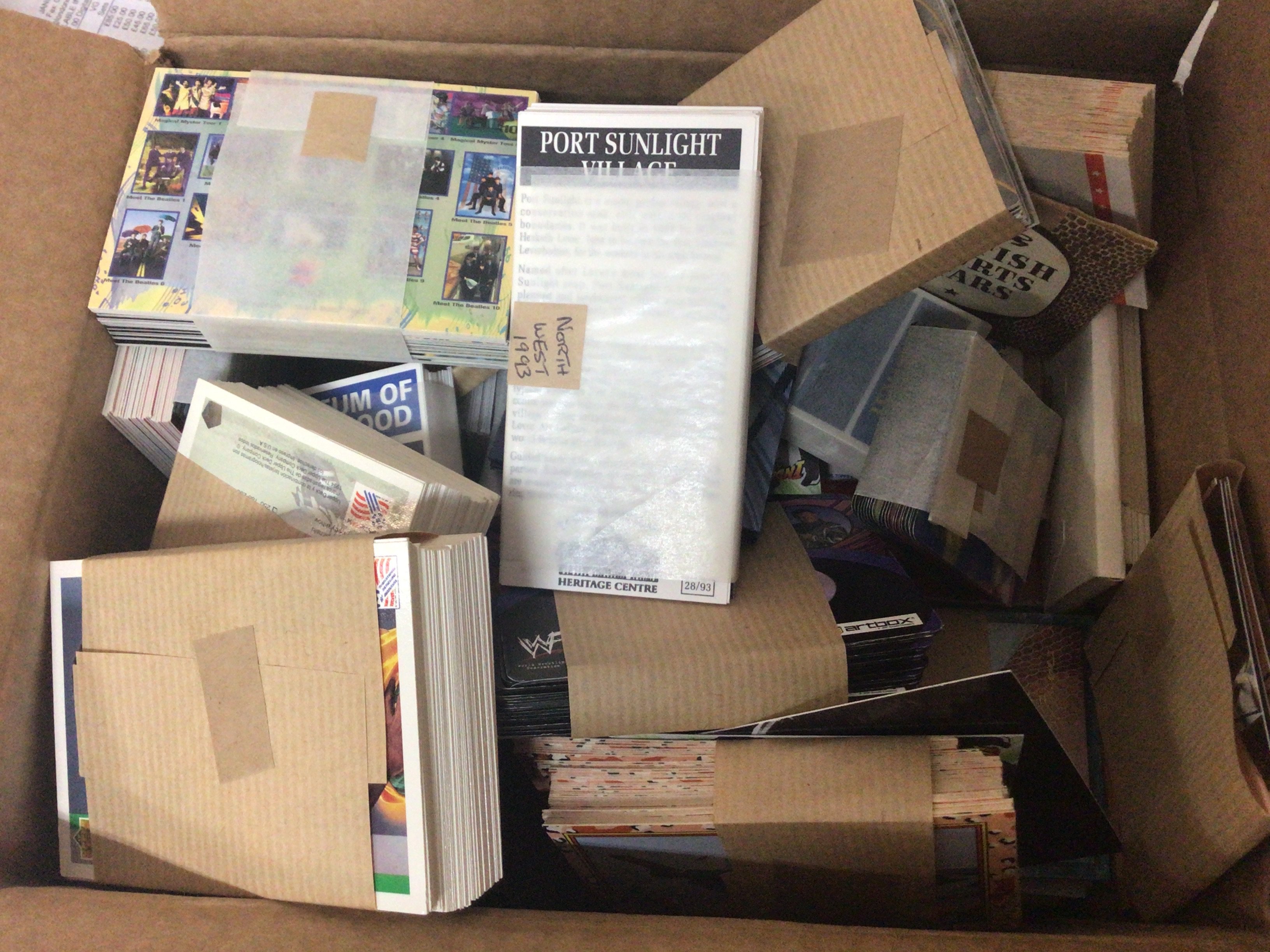 A box containing modern three dimensional WF wrestling Desert Storms football Legends and other modern cards. Advertising gummed labels and an album of interesting Elizabeth II covets stamps and other ephemera.