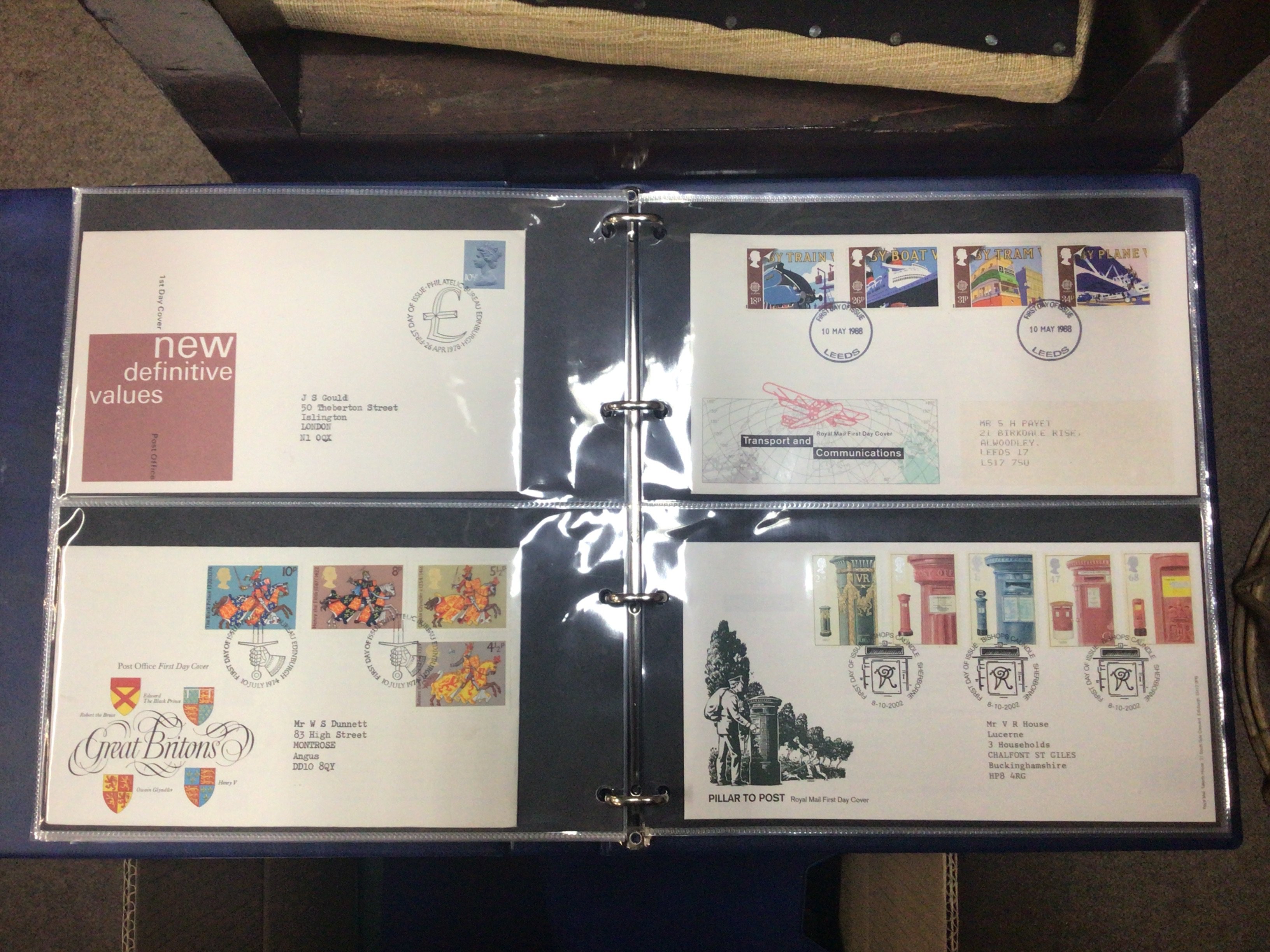 A box containing well presented albums of first day covers.