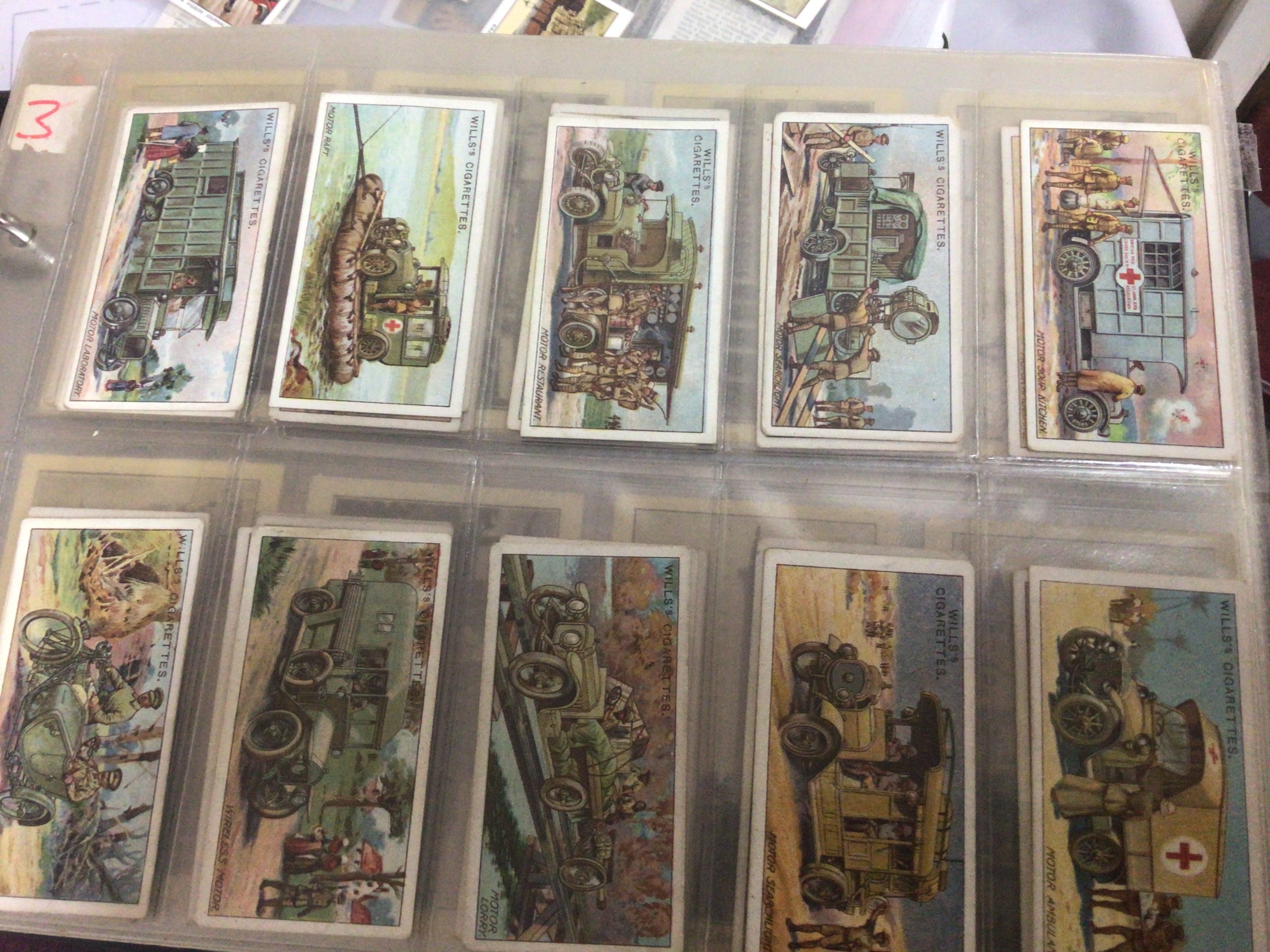 Five albums containing vintage cigarette cards and other collectors cards. Including Barrett football cards Space 1999 Bassett World Cup 74 cards The Conquest of Space 1980-81 Disney cards Vintage Adkin War Trophies Wills Military Motors and numerous others.