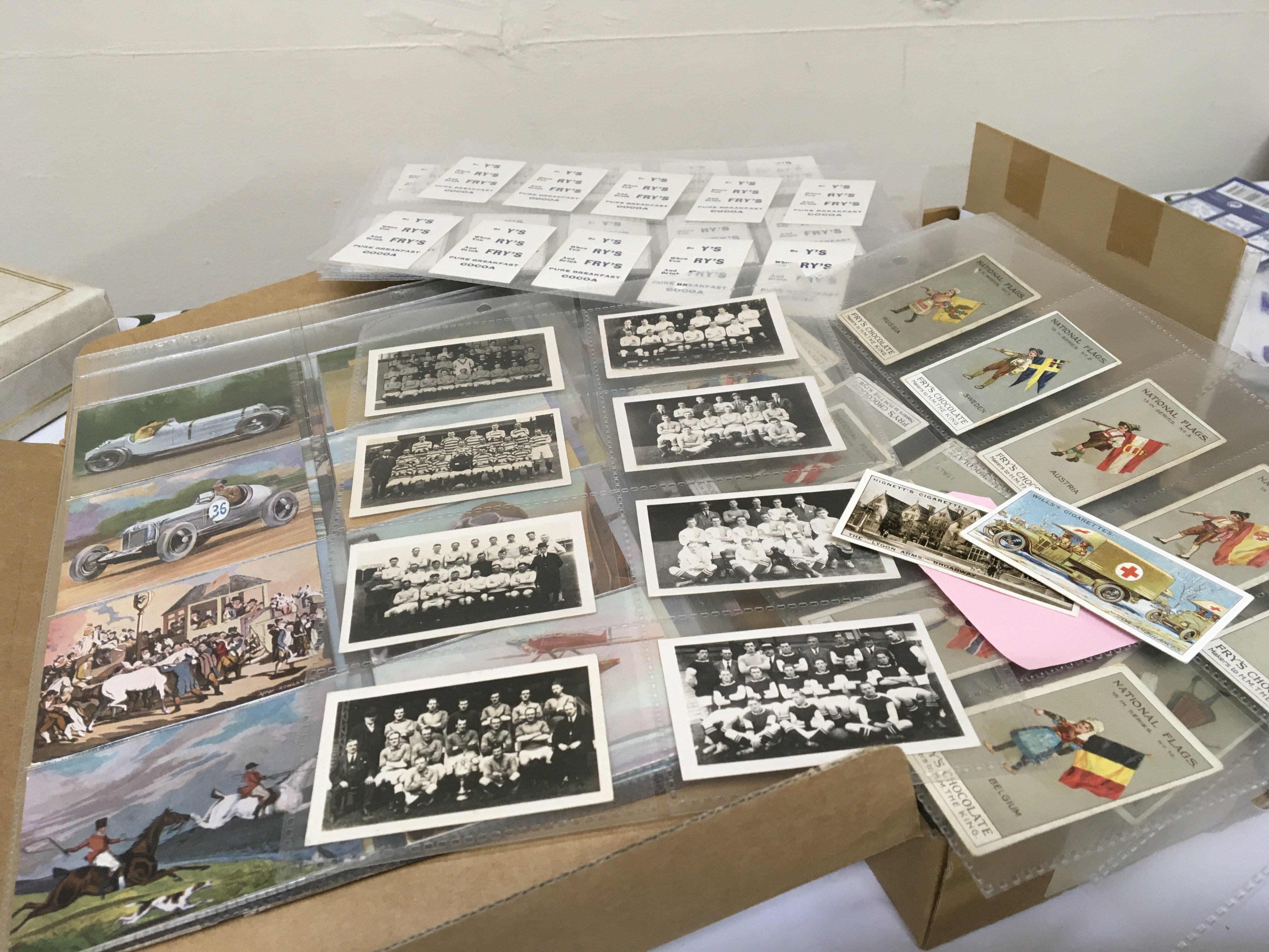 A box containing a good selection of vintage cigarette cards including Spped through the ages Wills Military motors British Livestock Vintage Chums football teams and numerous others and some postcards.