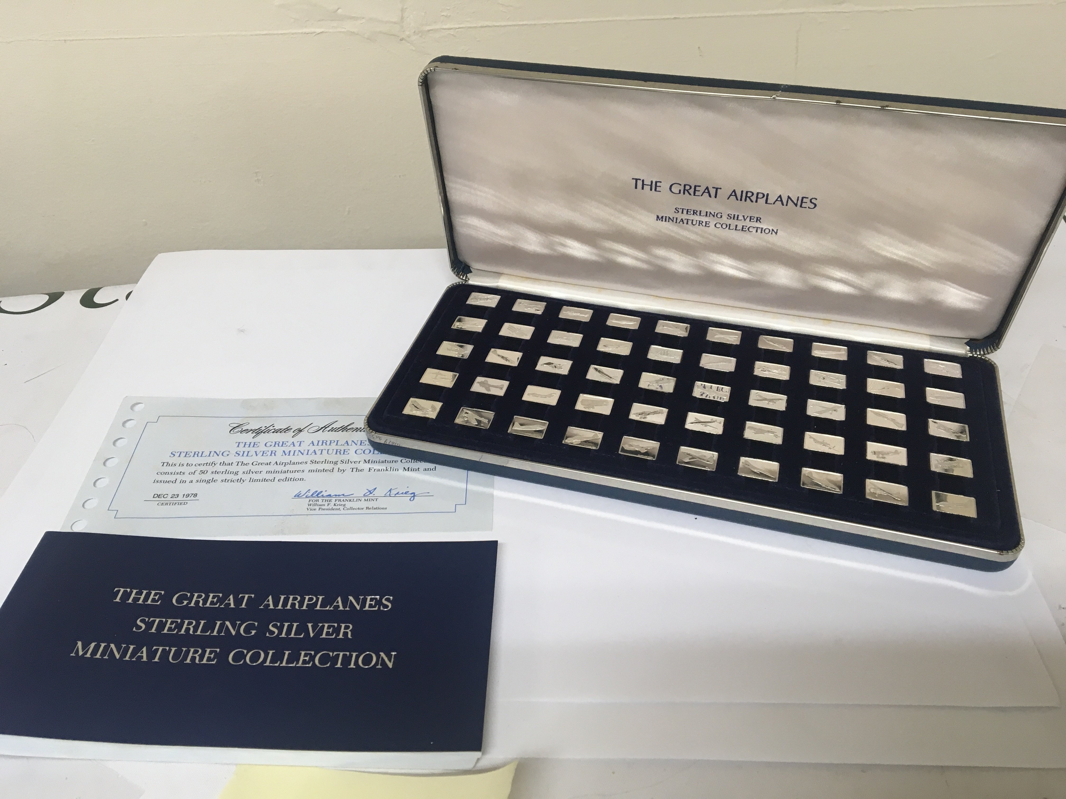 A presentation case containing miniature silver ingots The Great Airplanes collection fifty ingots with certificate of authenticity and references book.