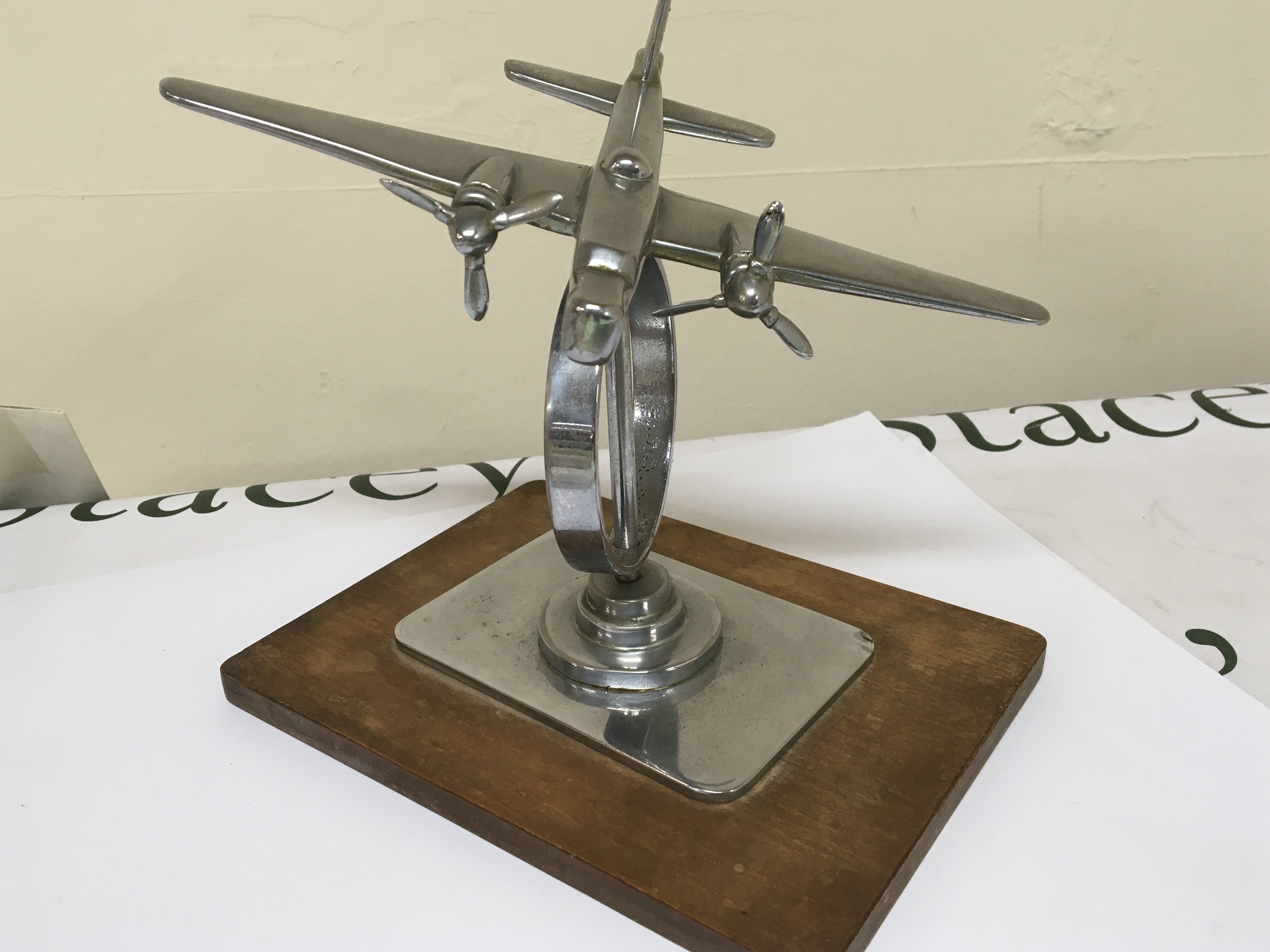A 1930 Chrome desk top model of an Aircraft with double propeller.