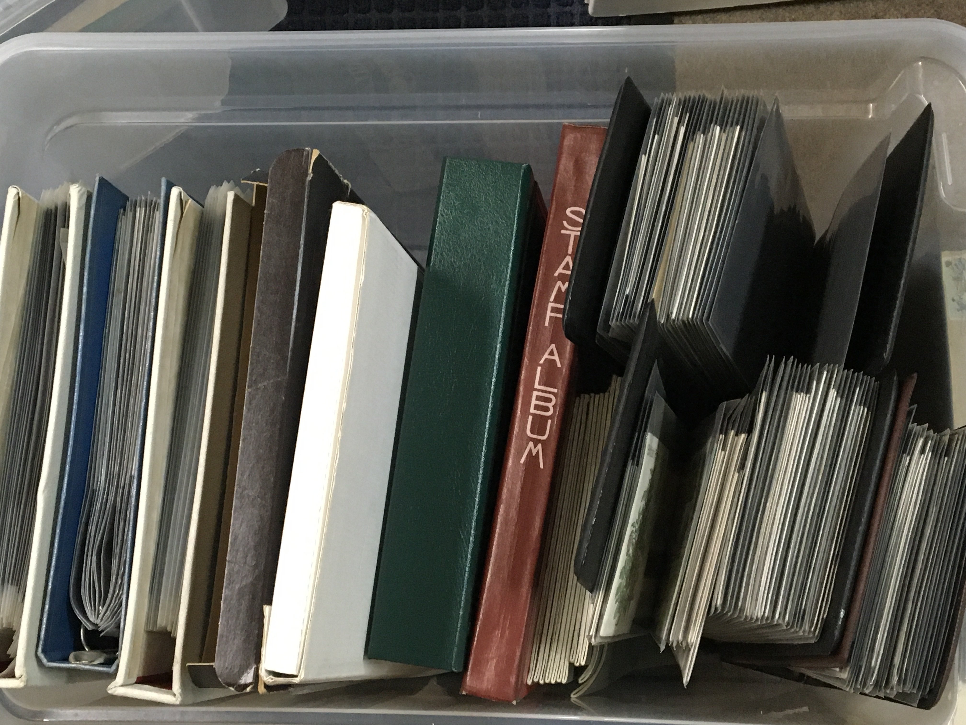 A box containing stamp albums containing mixed world stamps and albums of First day covers