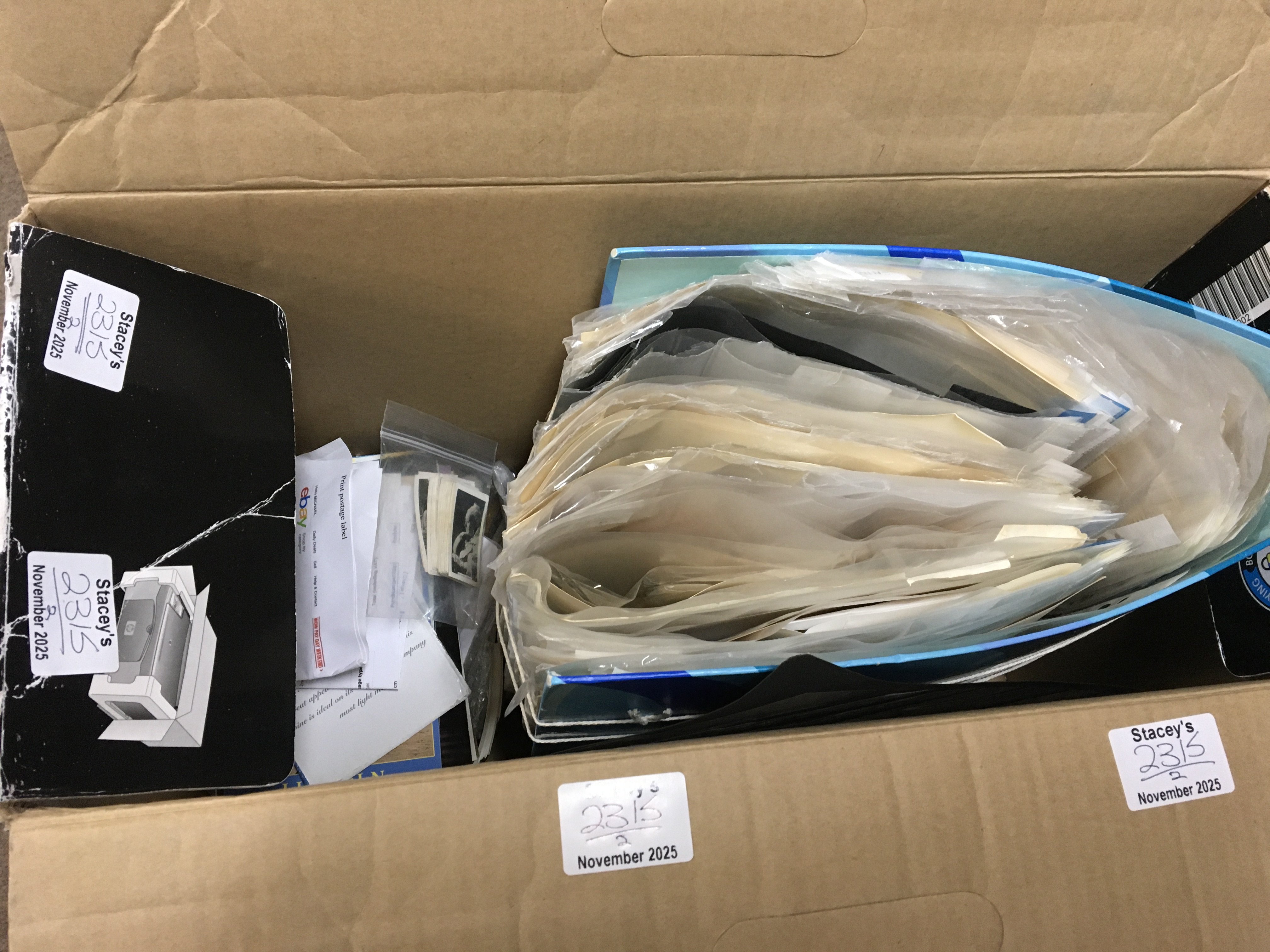 Two boxes containing mixed vintage cigarette cards and other related ephemera.