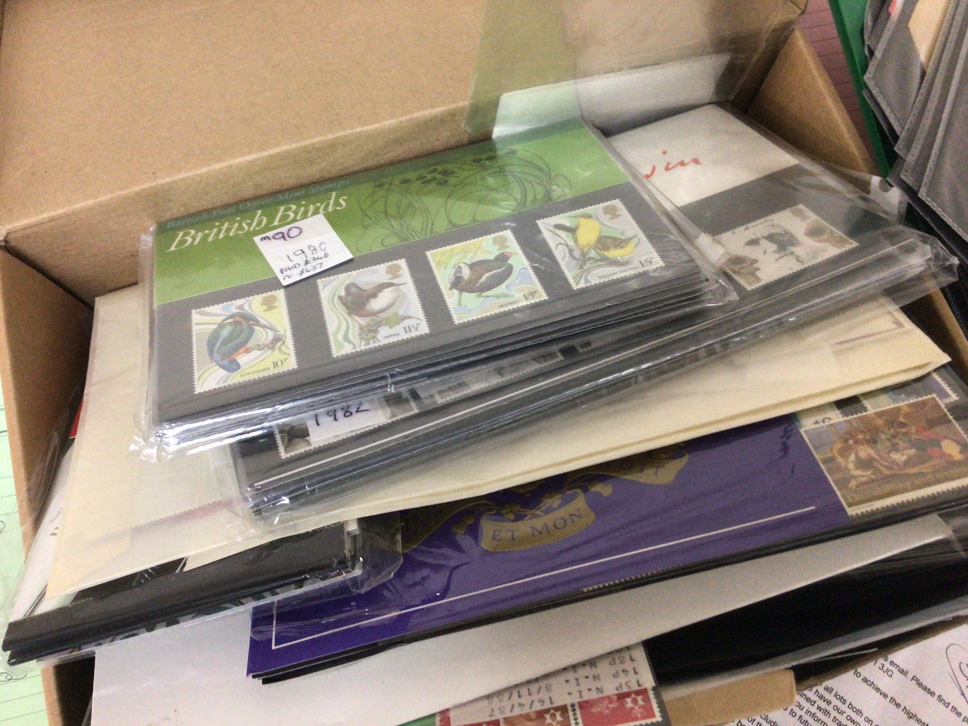 A box containing presentation stamp packs mixed Elizabeth II and pictorials and an album of interesting world first day covers early examples and other first day covers.