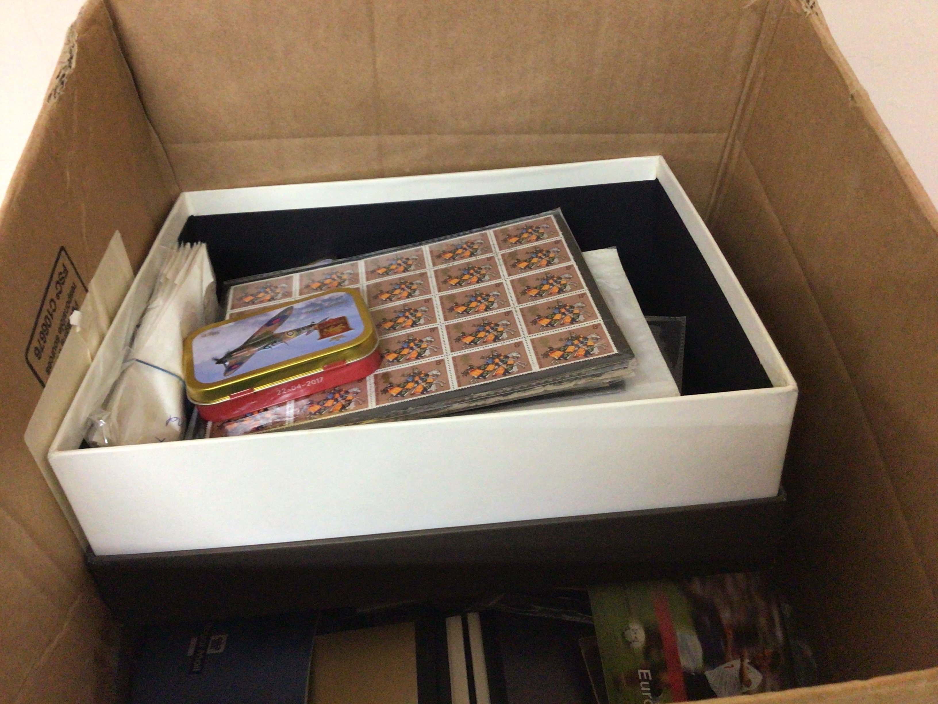 A box containing a quantity of unused Elizabeth II stamp books some pictorial sheets of unused stamps and first day covers and other assorted ephemera.