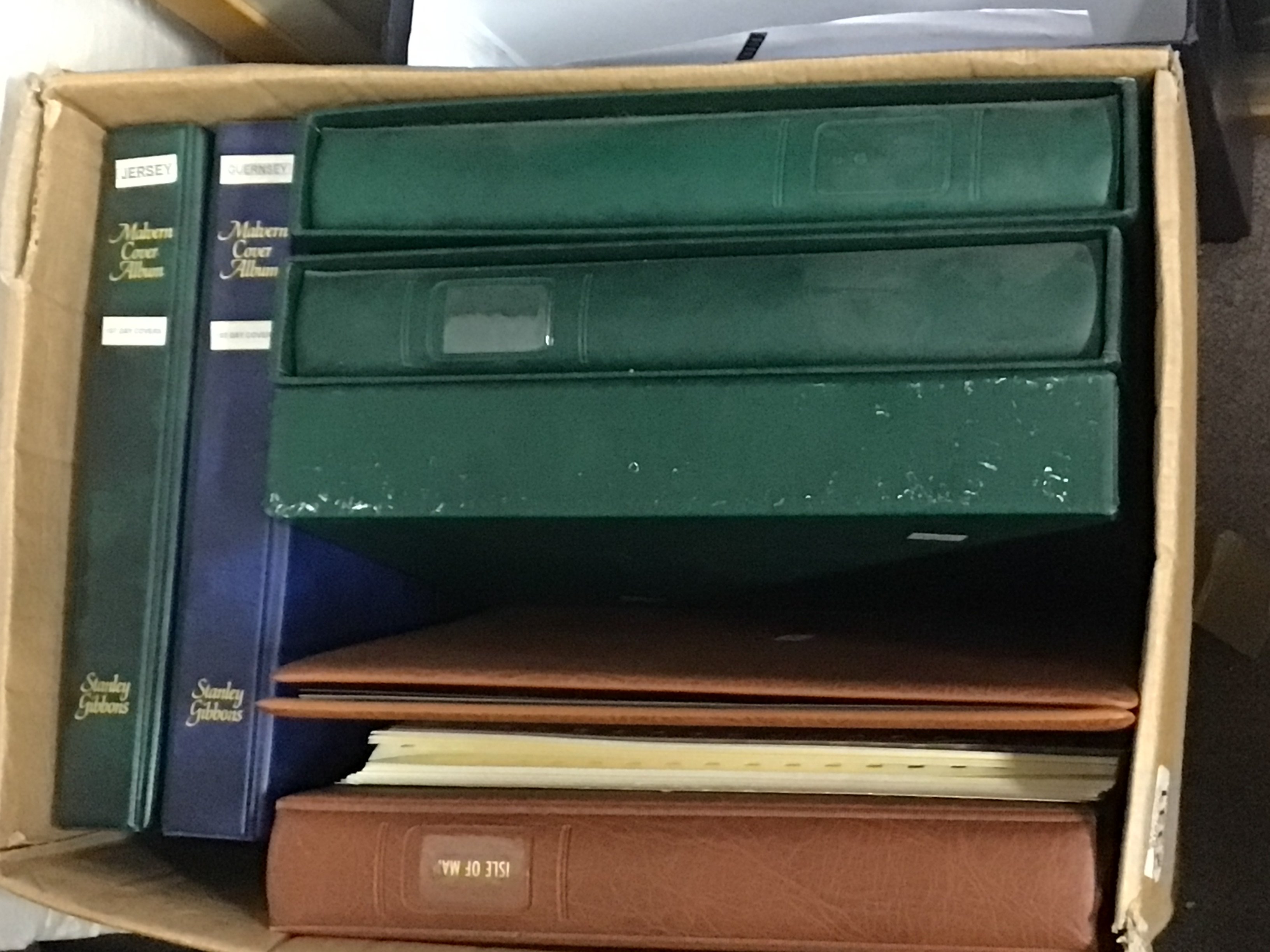 A box containing stamp albums. Including Many unused pictorial stamps Isle of Man Jersey Guernsey and others.