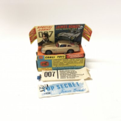 A boxed 261 Corgi James Bond 007 gold coloured Aston Martin DB5. Includes 2x ejector passengers and 007 secret instructions. All parts in working order.