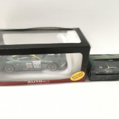 Two boxed Aston Martin model cars. Including Autoart 1:18 scale 24 hour Le Mans 2005 DBR9 car no.59. Also a 1:43 scale 24 hour Le Mans 2005 DBR9 car no.59. By Aston Martin Racing. No reserve