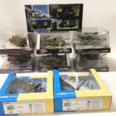 A collection of 9 boxed WW11 themed diecast models by Corgi and Lledo. Includes planes..Tank. Etc.