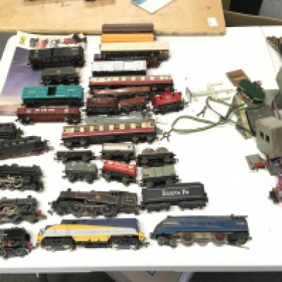 A collection of 00 gauge model railway trains and accessories including 8 locomotives..20 wagons and coaches..plus 3 lane track. Also includes a steam locomotive 0 gauge.