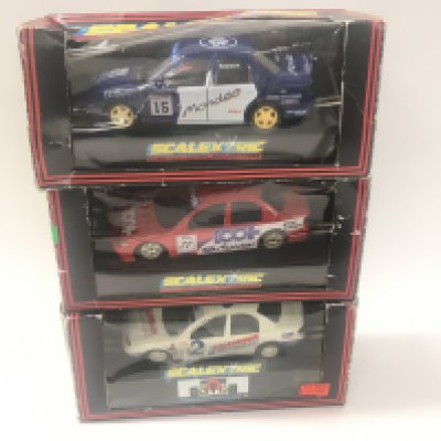 A collection of 3 boxed Scalextric cars featuring a Red a White and a Blue Ford Mondeo Cosworth. C.424. C716. C.579