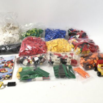 A collection of bags containing Lego bricks and accessories. No reserve