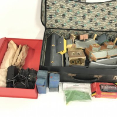 A box containing a collection of buildings , transformers and various other accessories. All playworn. No Reserve.