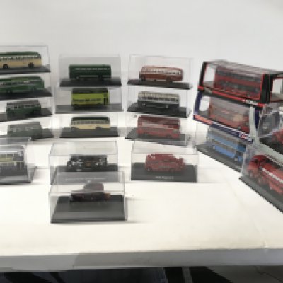 A collection of 19 diecast model vehicles in display boxes featuring buses..fire engines..tanker etc. manufacturers include Corgi..Oxford etc. no reserve