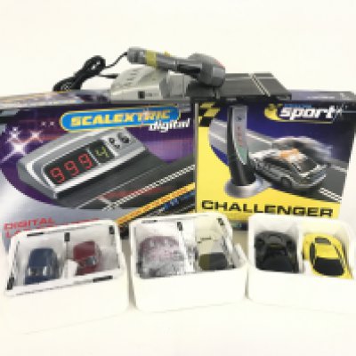 A box containing 6 Scalextric cars. As well as a Digital Lap counter. A safety car challenger. No reserve.