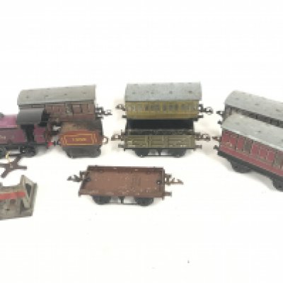 A 1950s 0 Gauge Locomotive with Carriages.