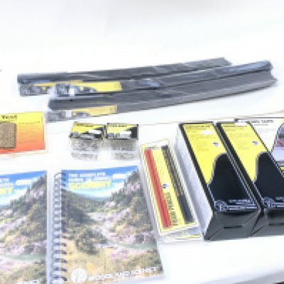 A collection of Woodland Scenics accessories including track bedding and profile boards. Also includes books The Complete Guide To Model Scenery. No reserve