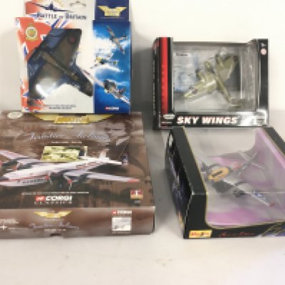 A collection of four model aircraft in original display packaging by Corgi..MotorMax and Maisto. Includes 47203 and a Battle of Britain set plus others.