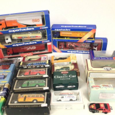 A collection in excess of 20 boxed model vehicles including cars ..buses and commercials. Manufactured by Corgi..Lledo..Saico etc. No reserve